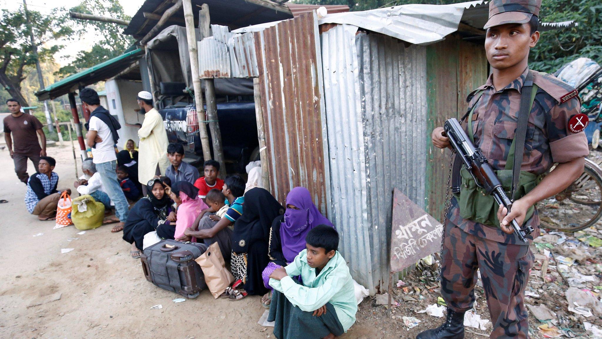 Policeman stands guard after catching Rohingya Muslims illegally crossing at a border check point in Cox's Bazar, Bangladesh, November 21, 2016