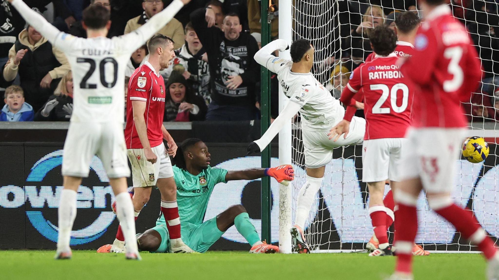 Arthur Okonkwo (in green) drops the ball and allows Adam Idah to score for Swansea