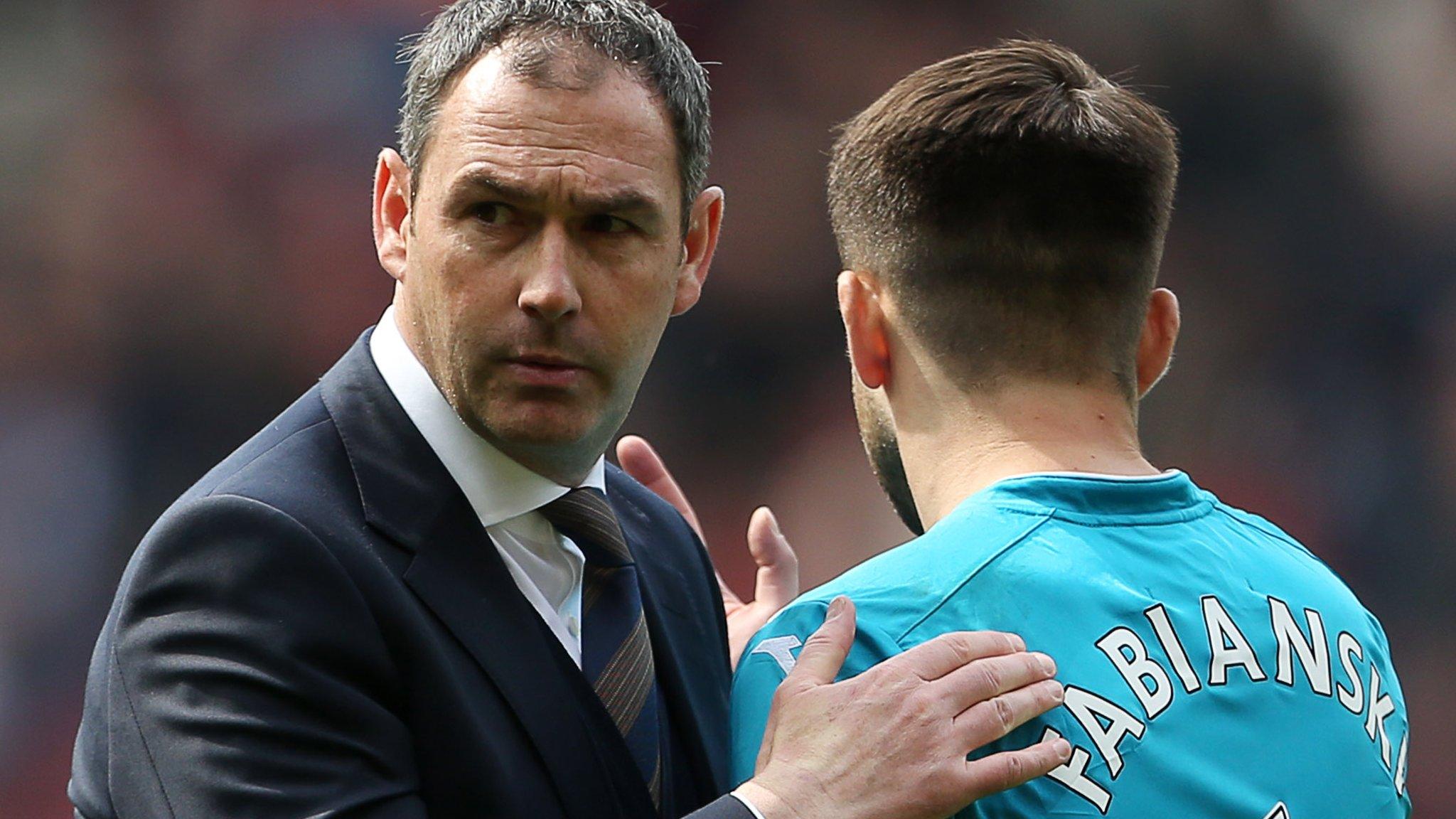 Swansea City manager Paul Clement consoles goalkeeper Lukasz Fabianski