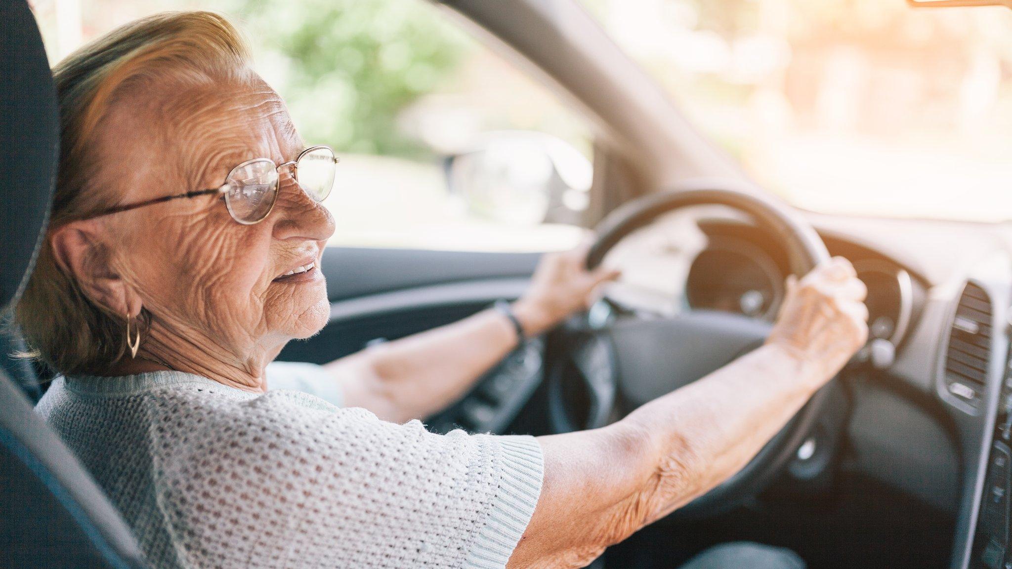 A woman behind the steering wheel of a car