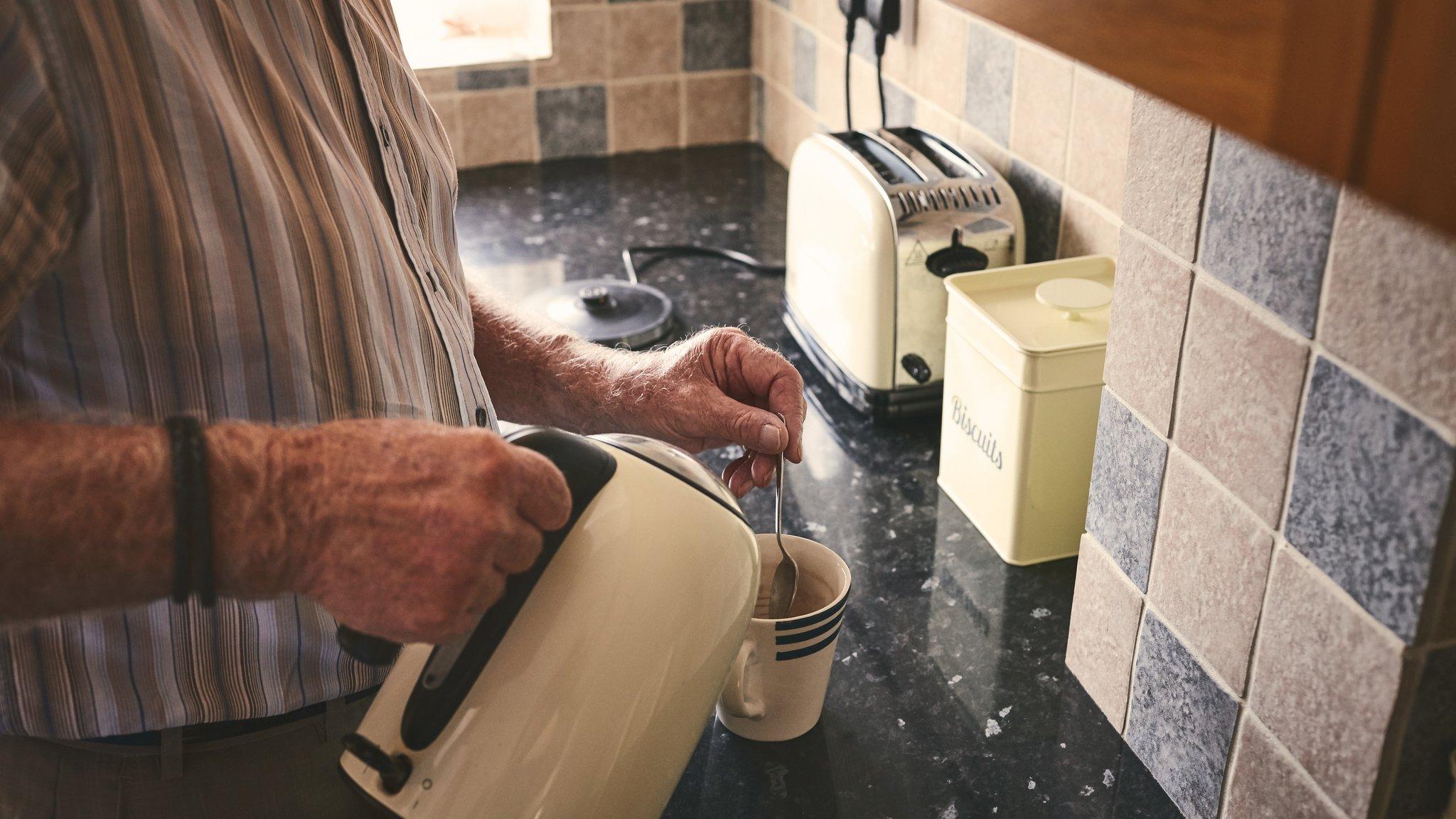 Stock picture of an old man making tea