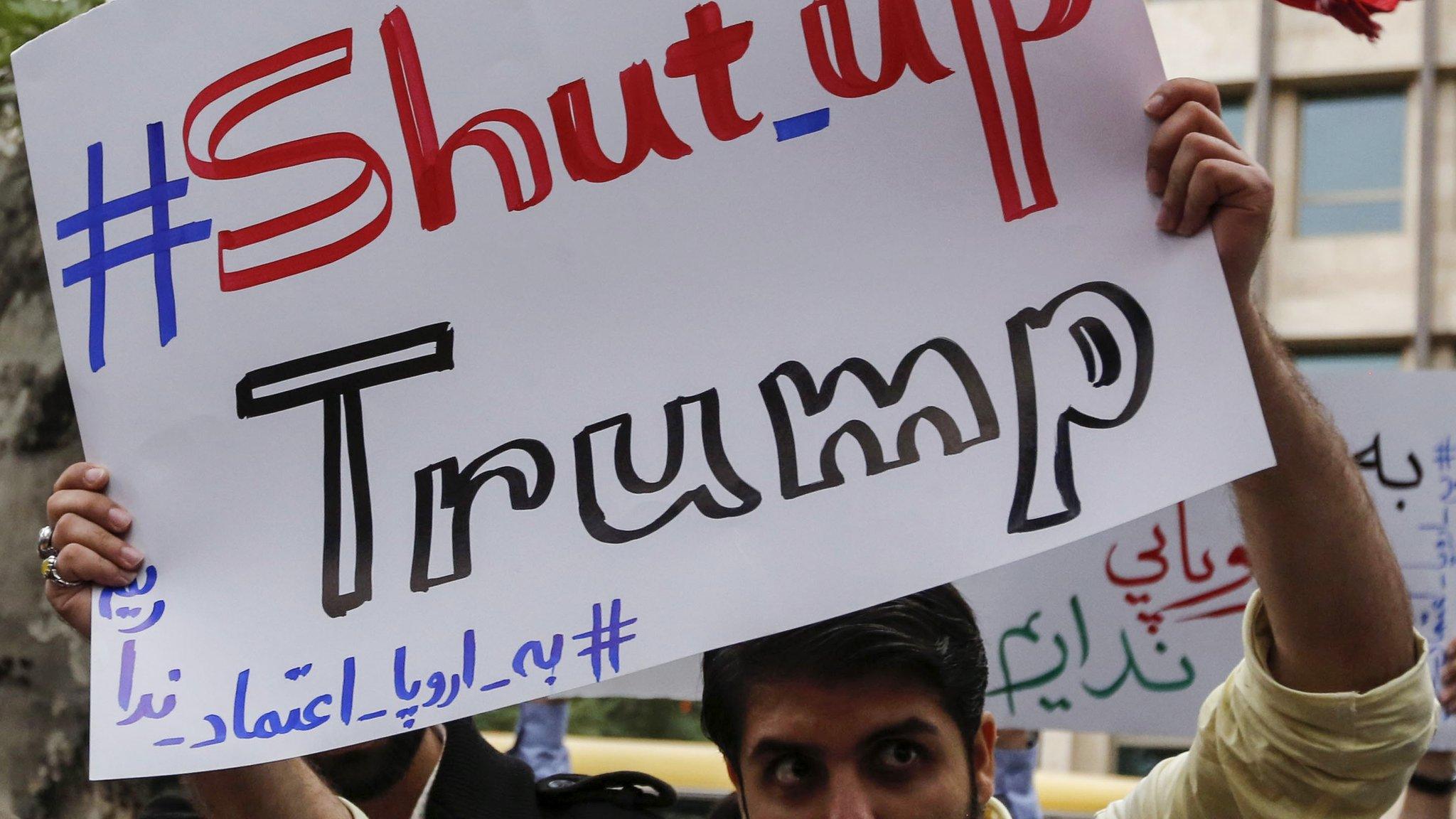 Iranian man holds up a banner saying: #Shut_up Trump" at a protest outside the former US embassy in Tehran on 9 May 2018