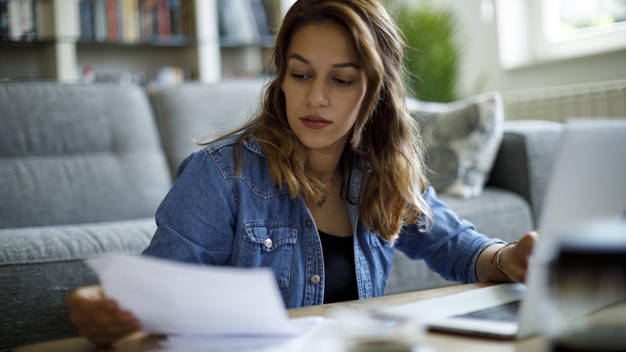 Woman looking at energy bills