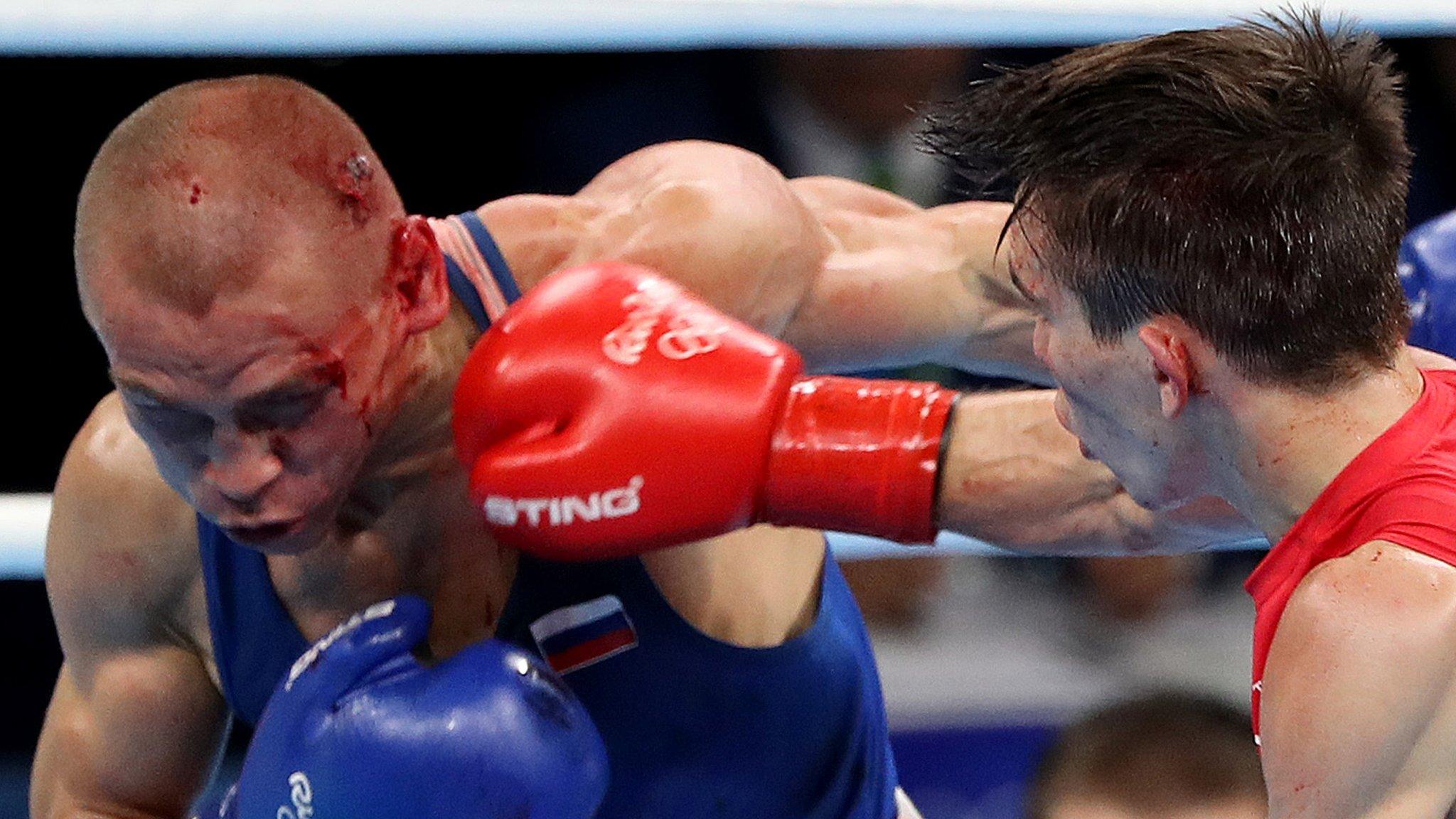 Michael Conlan lands a right hand on a bloodied Vladimir Nikitin in Tuesday's bantamweight contest in Rio