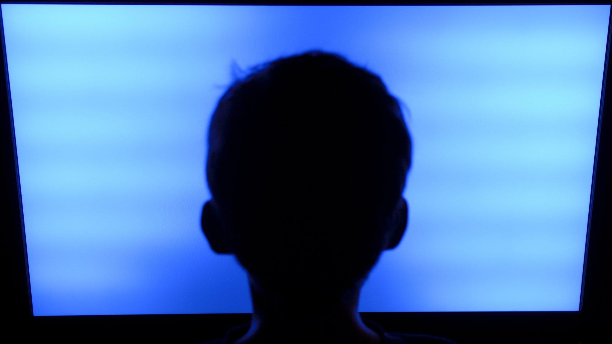 Child in front of TV screen