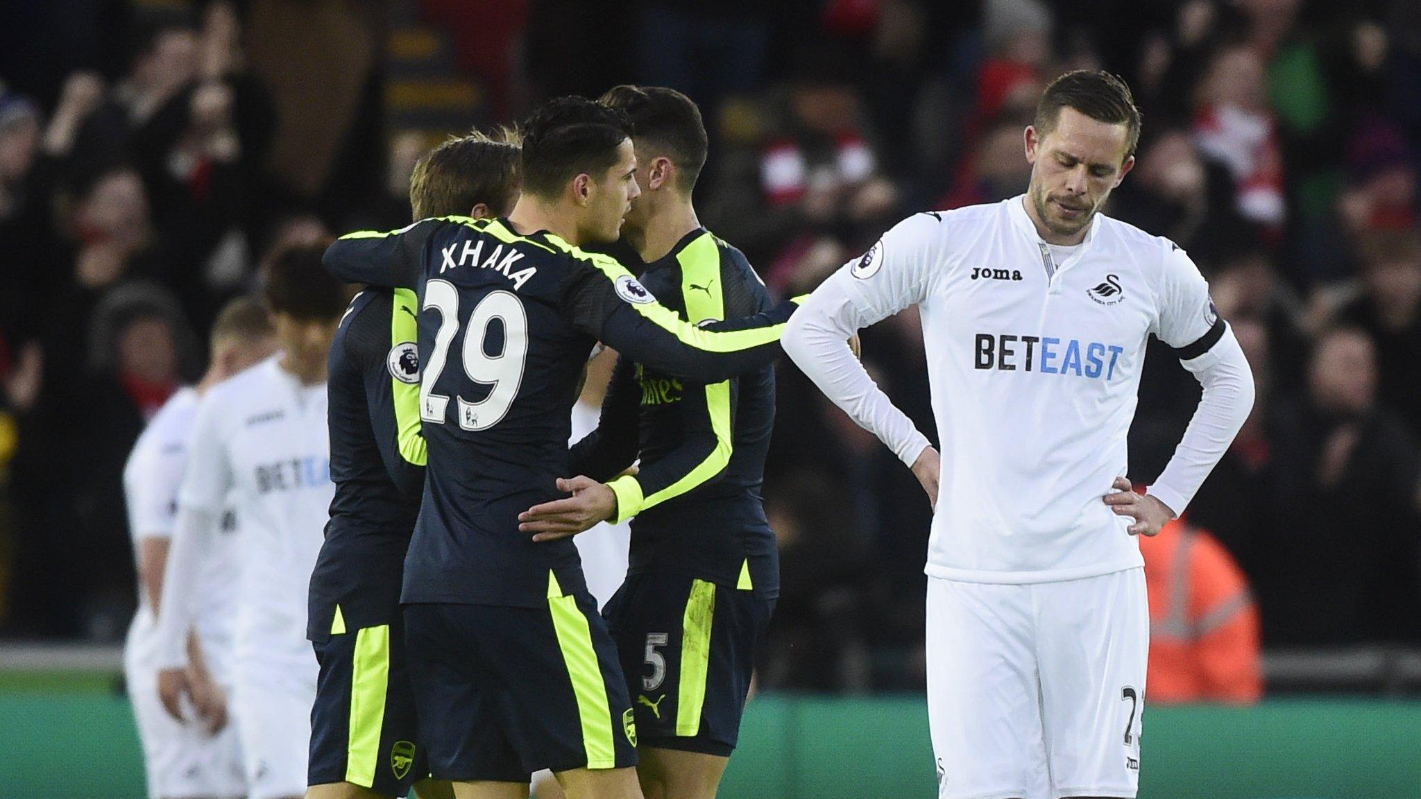 A dejected Gylfi Sigurdsson as Arsenal celebrate