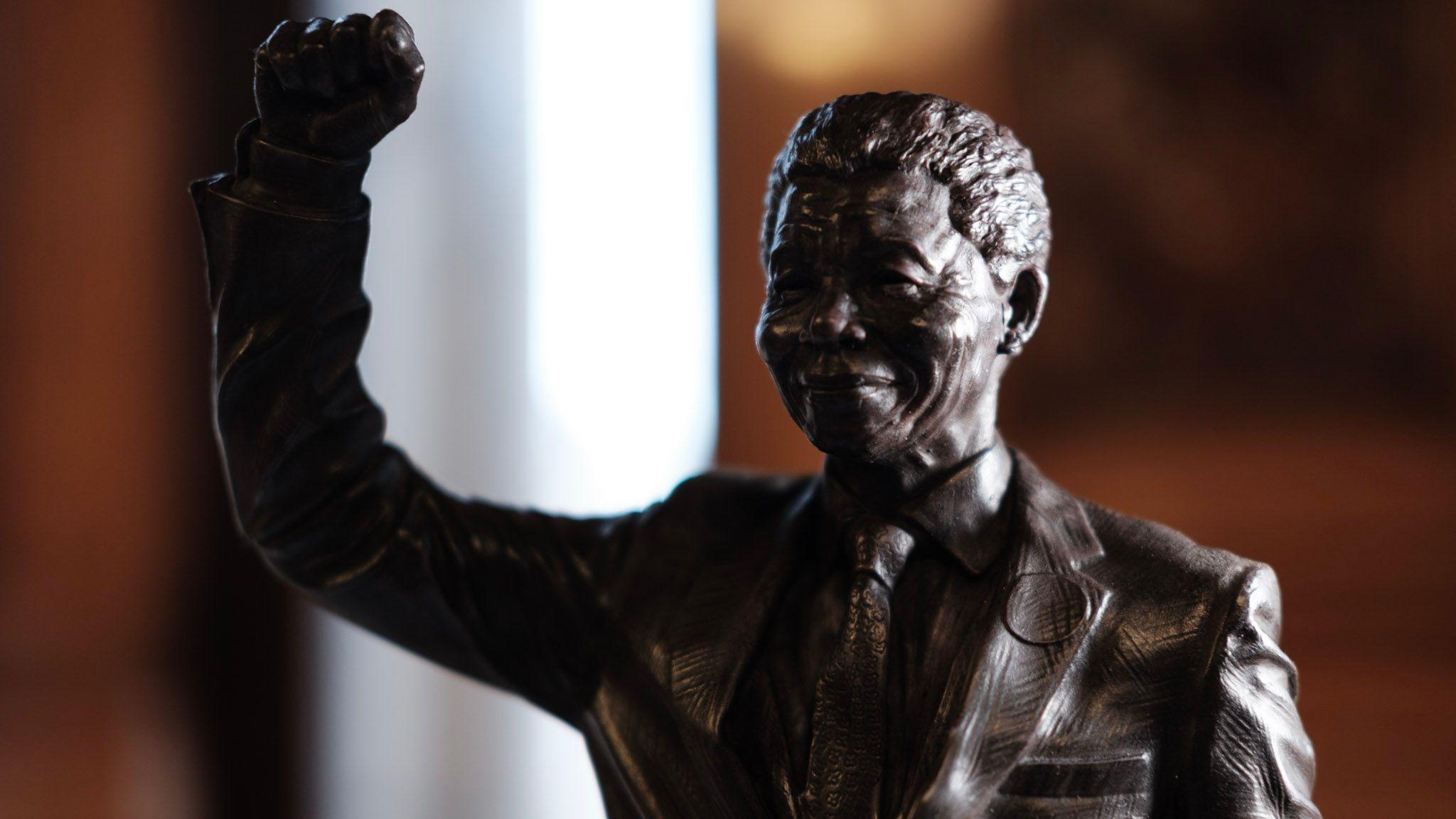 A proposed statue of Nelson Mandela. It has Mandela standing with one arm raised in the air