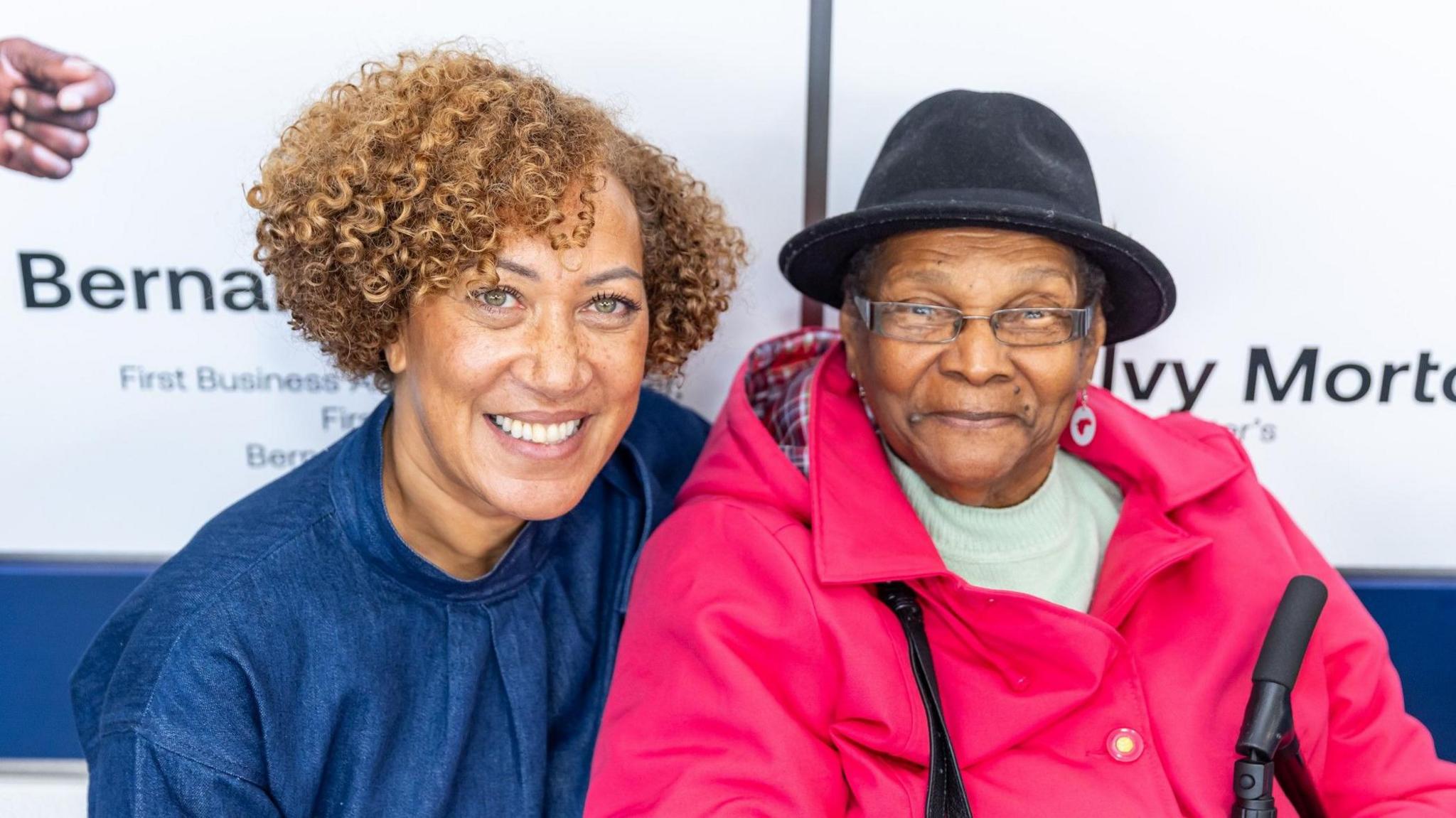 Two women smiling at the camera.