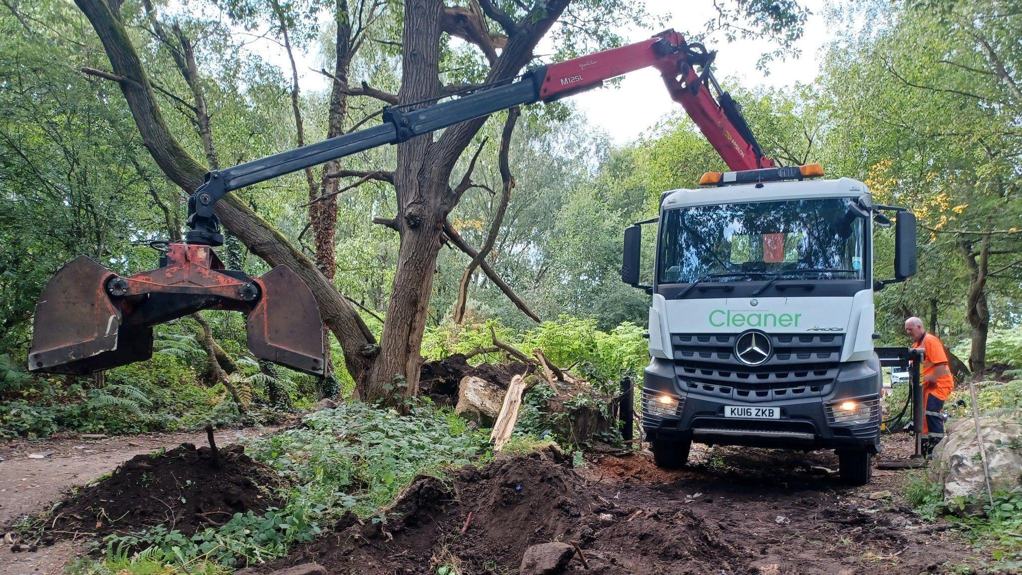 The clean-up truck in action in a wooded area