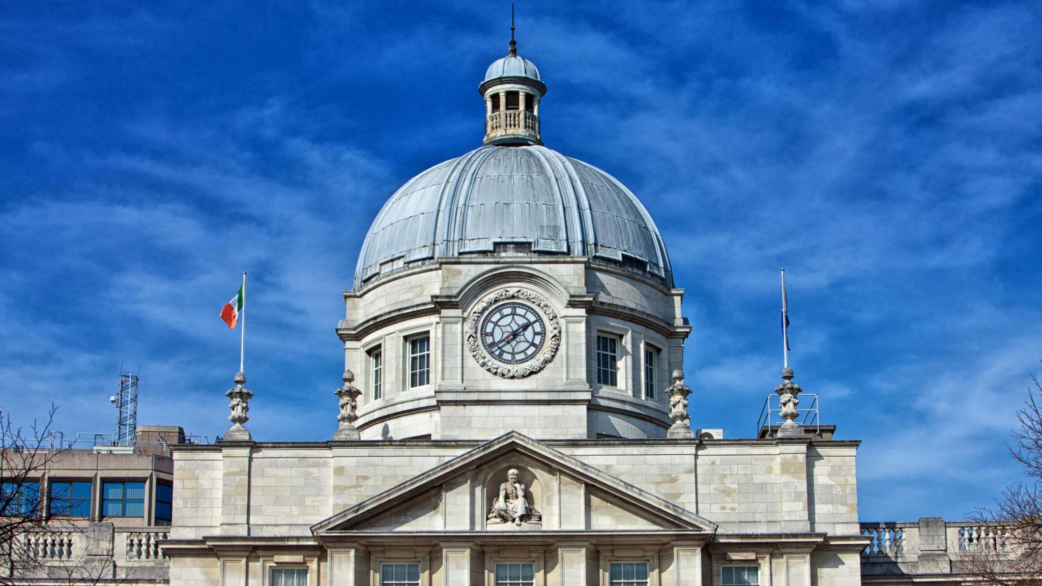 Leinster House - An exterior shot of a white stone building with a large blue-topped dome against a blue sky.