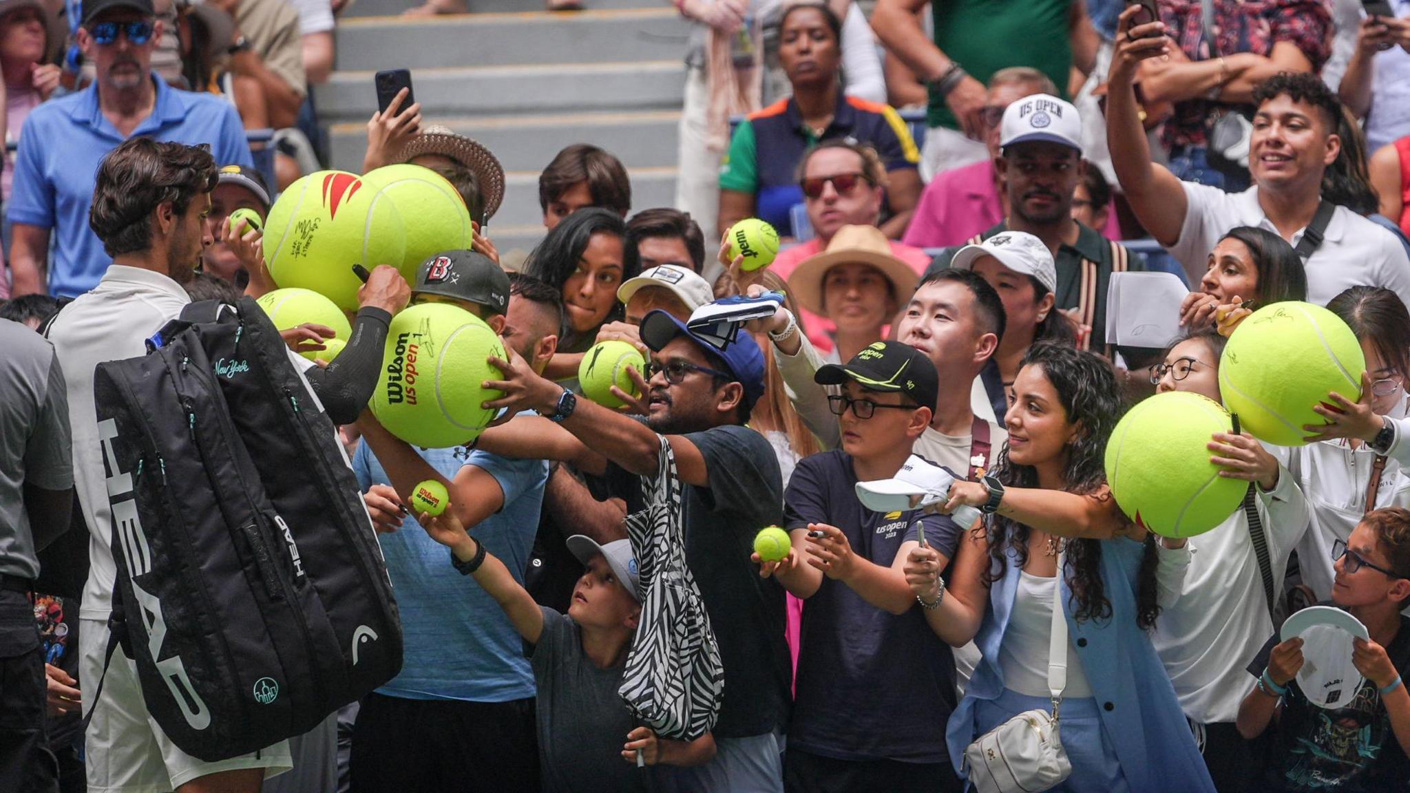 US Open fans wait as Lorenzo Musetti signs autographs