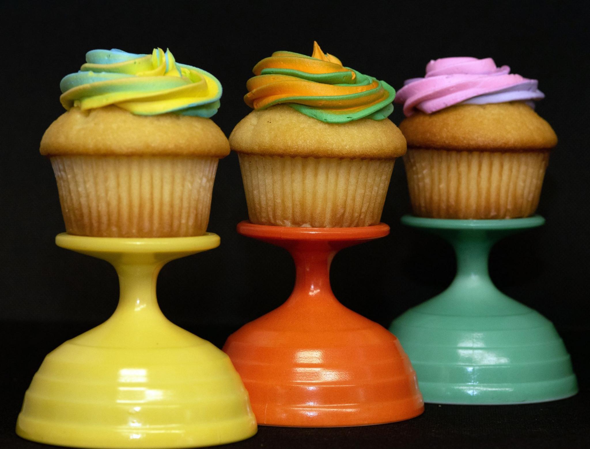 Colourful cup cakes on stands