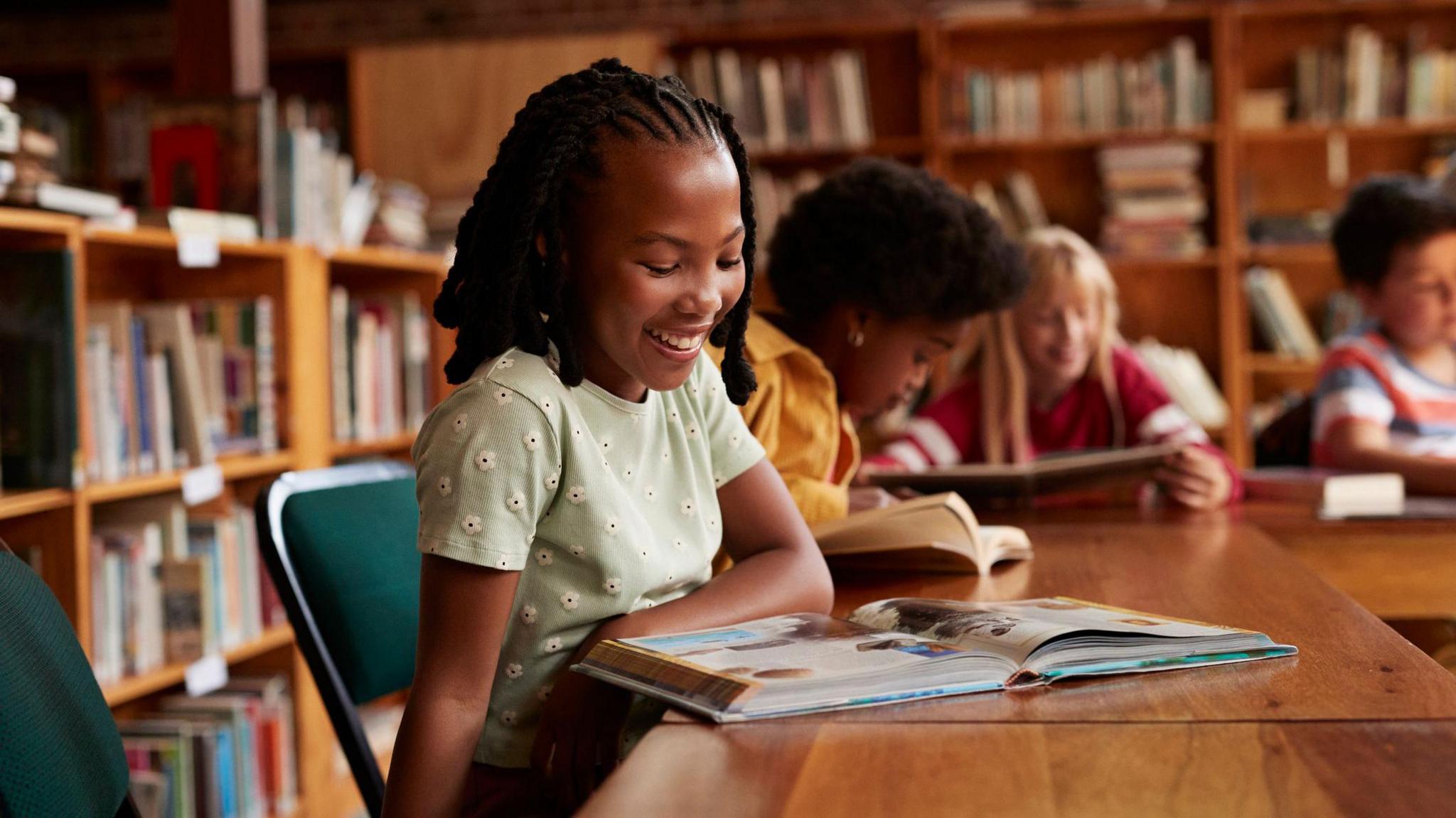 a girl reading a book in the library