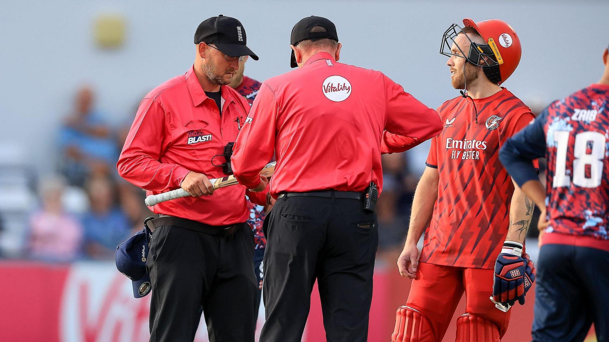 The match umpire removes Lancashire Lightning' Phil Salt's bat due to it being too big during the Vitality T20 Blast North Group match between Northants Steelbacks and Lancashire Lightning
