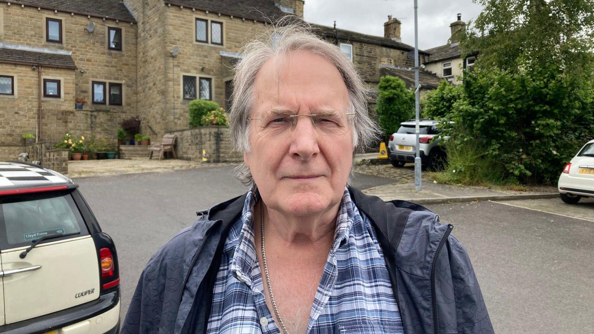 Phil Henderson standing in a car park in the village of Haworth