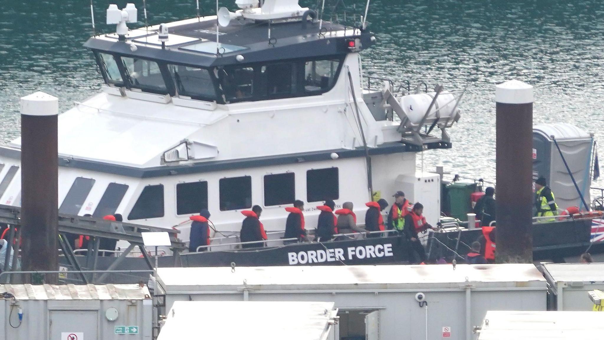 A group of people thought to be migrants are brought in to Dover