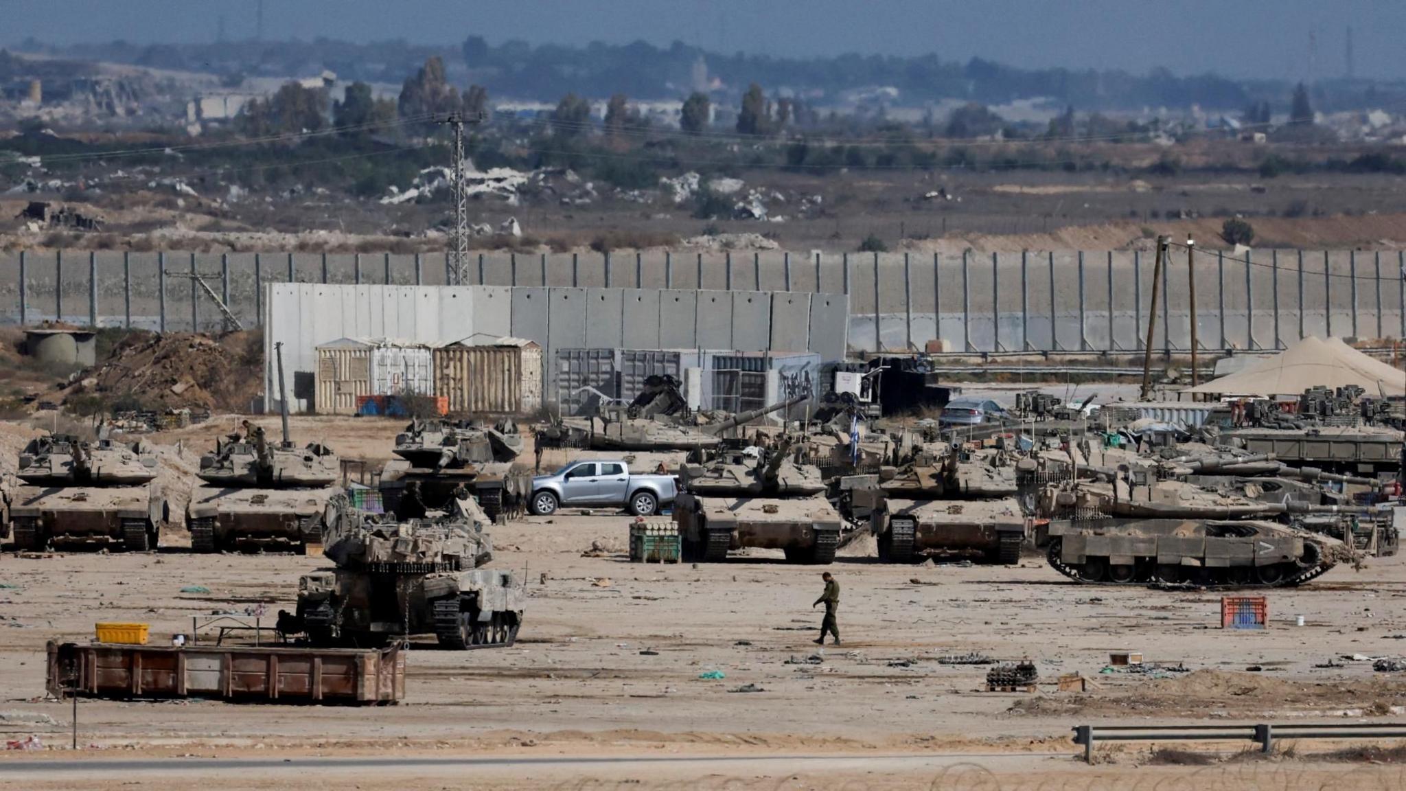 Israeli military personnel and tanks are stationed on the Israeli side of the Gaza perimeter, as seen from southern Israel (29 October 2025)
