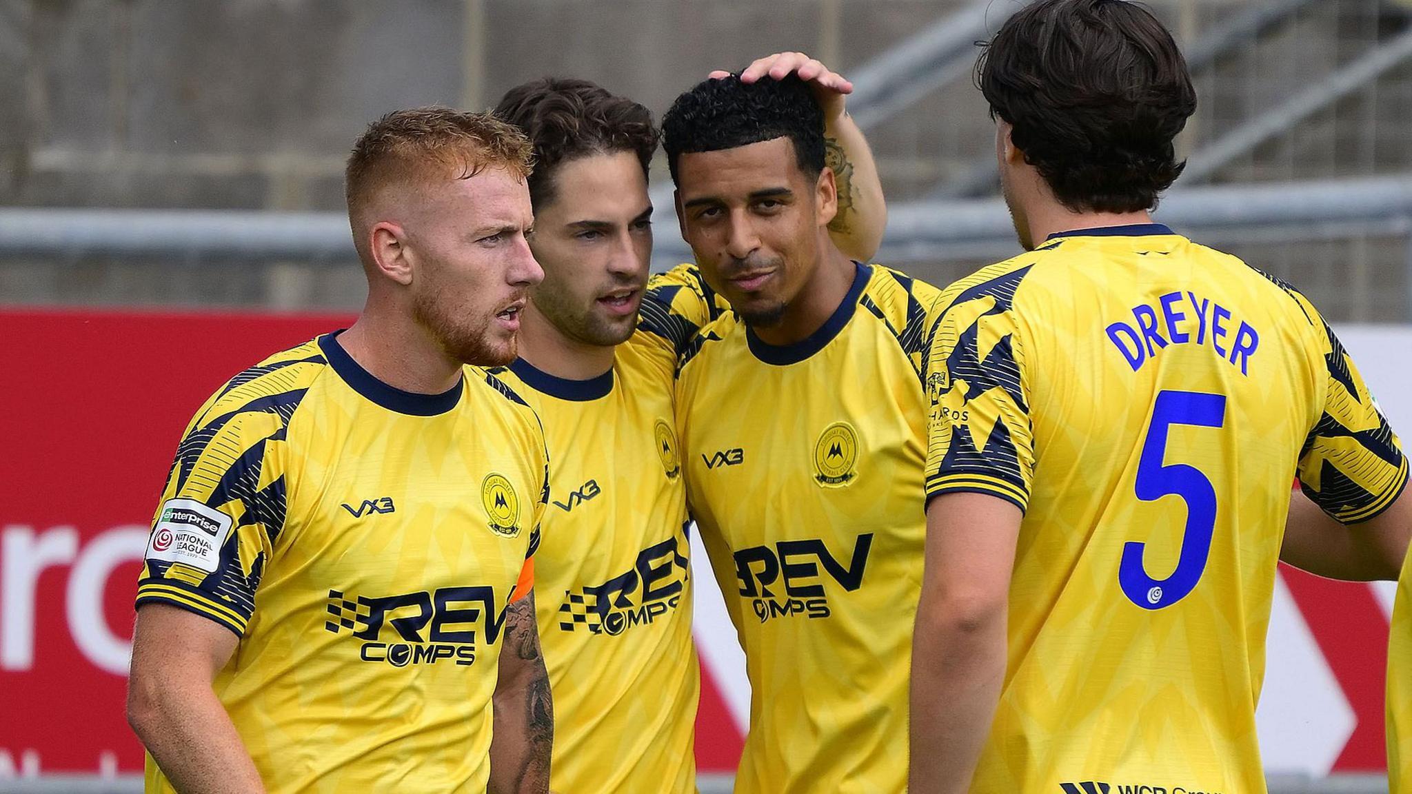 Jordan Young (centre left) and Louis Dennis (centre right) celebrate a goal