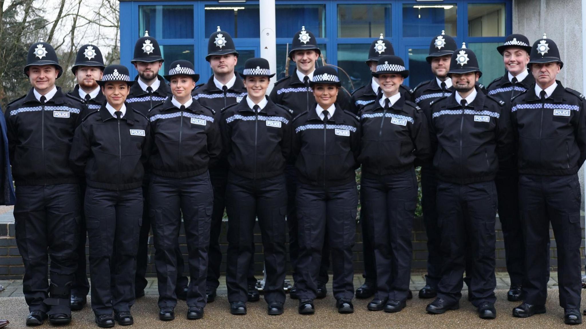 New recruits posing for a group photo at a passing out parade