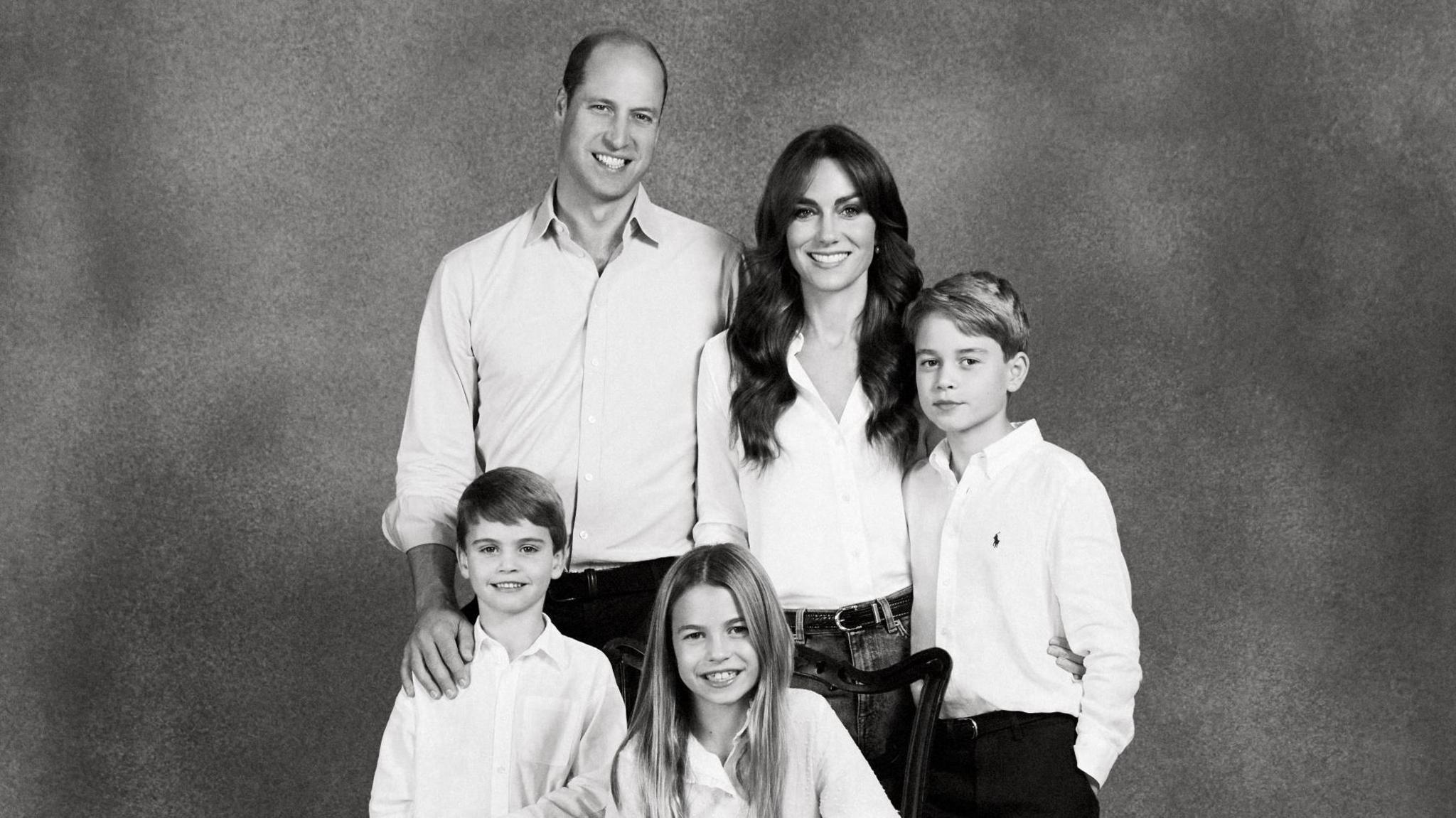 Prince William and Catherine with their children in their 2023 card. The couple and their three children are dressed in smart, casual clothes, in a black-and-white photograph.