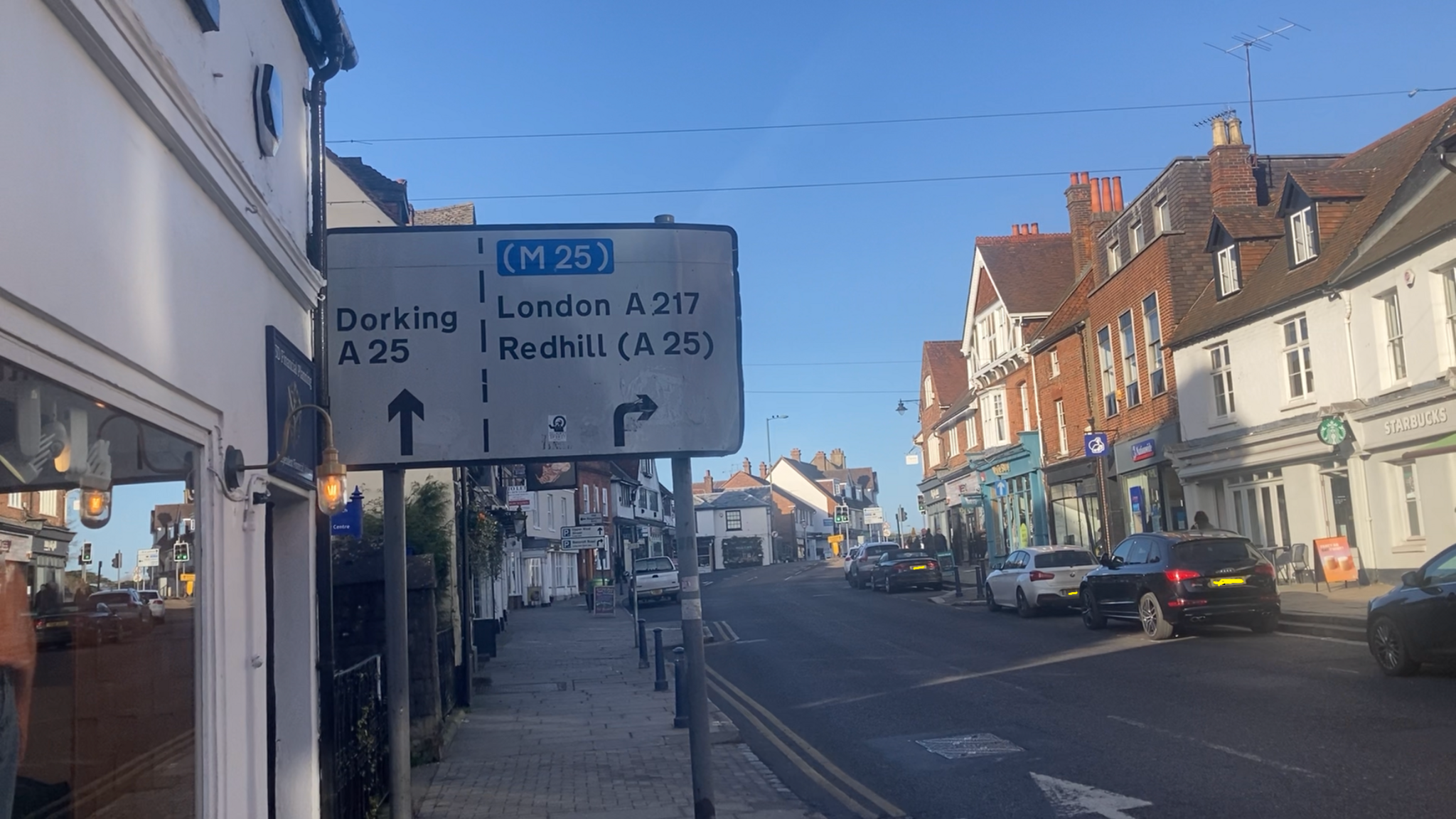 Reigate High Street, sign with directions to Dorking, M25, London and Redhill