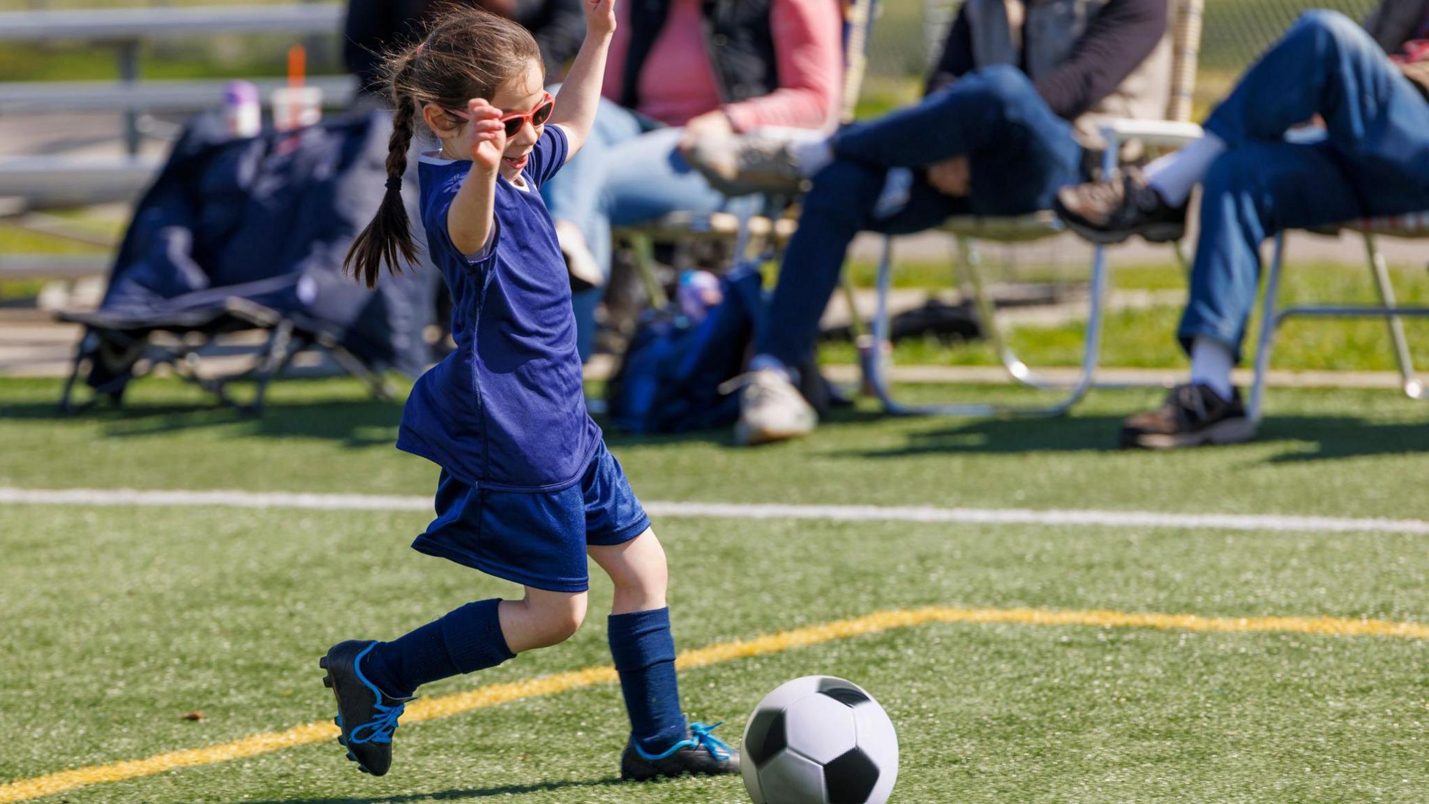 Girl playing football on the field