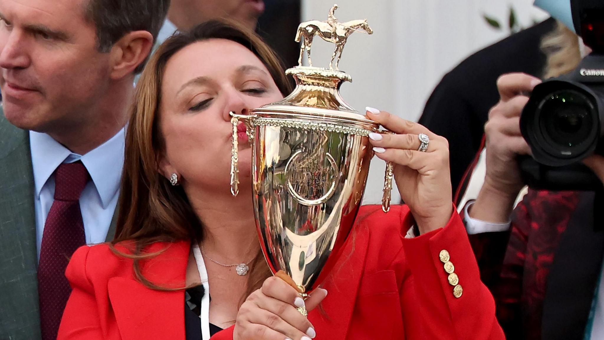 Cherie DeVaux kisses the Kentucky Derby trophy