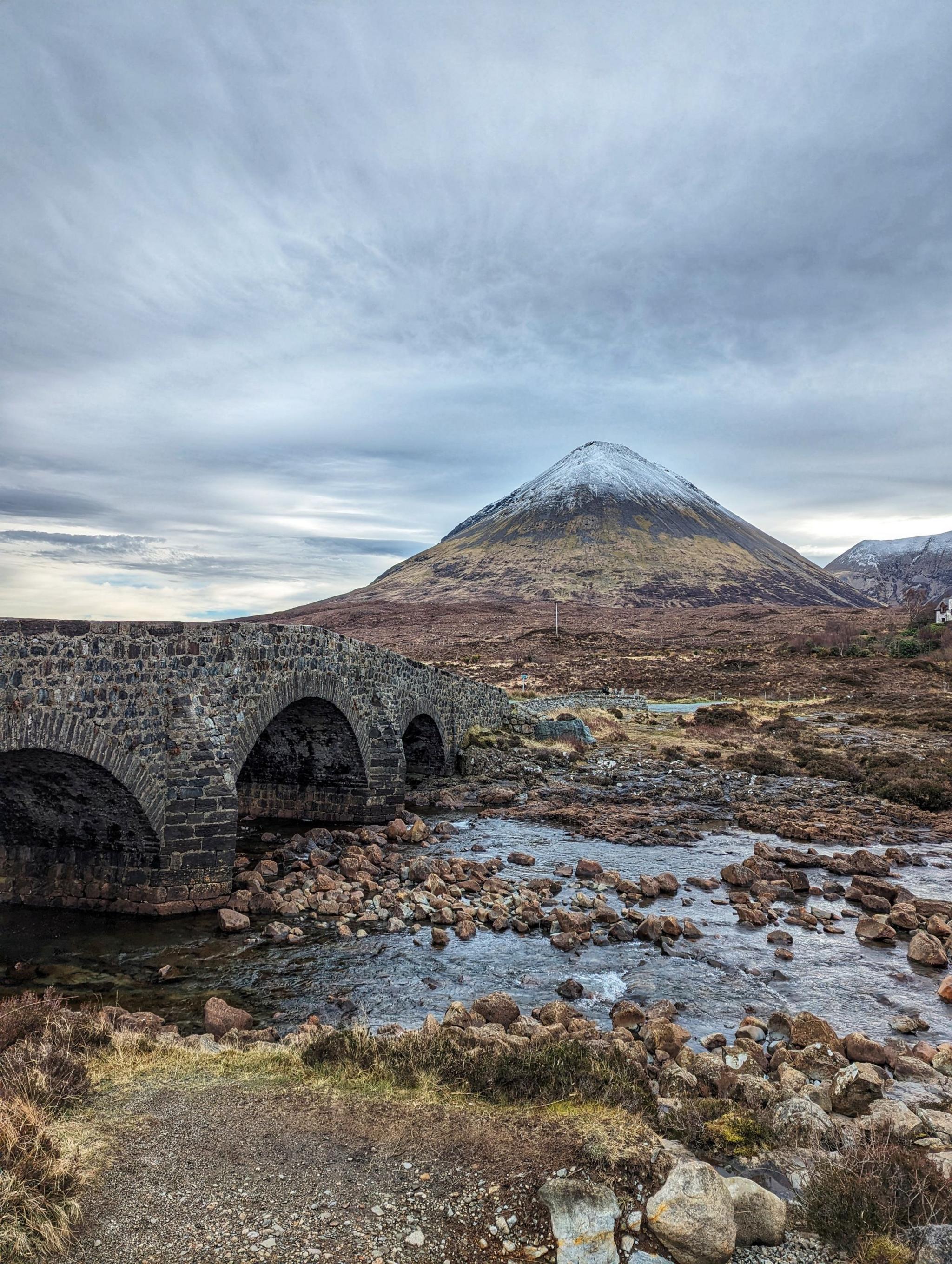 Stone bridge with a hill in the background