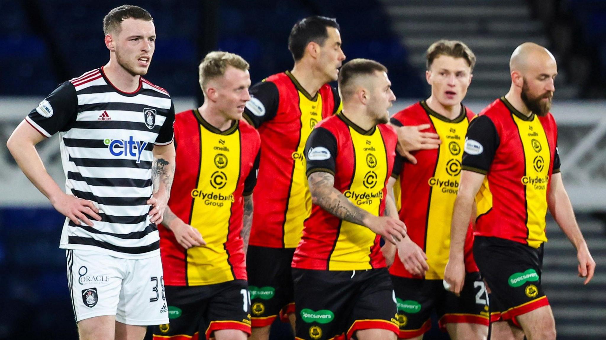 Queen's Park's Leon King (L) looks dejected as the Partick players celebrate Logan Chalmers' opening goal during a William Hill Championship match between Queen's Park and Partick Thistle at Hampden Park