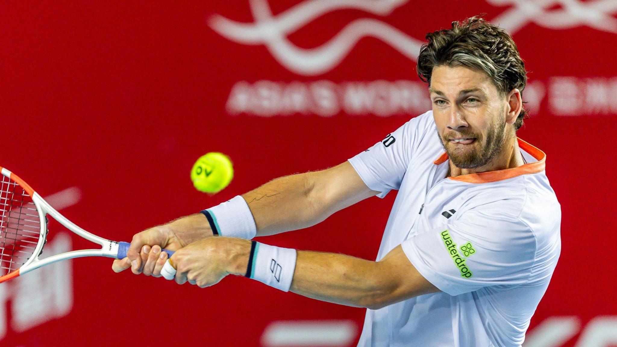 Cameron Norrie hits a return against Kei Nishikori at the Hong Kong Open