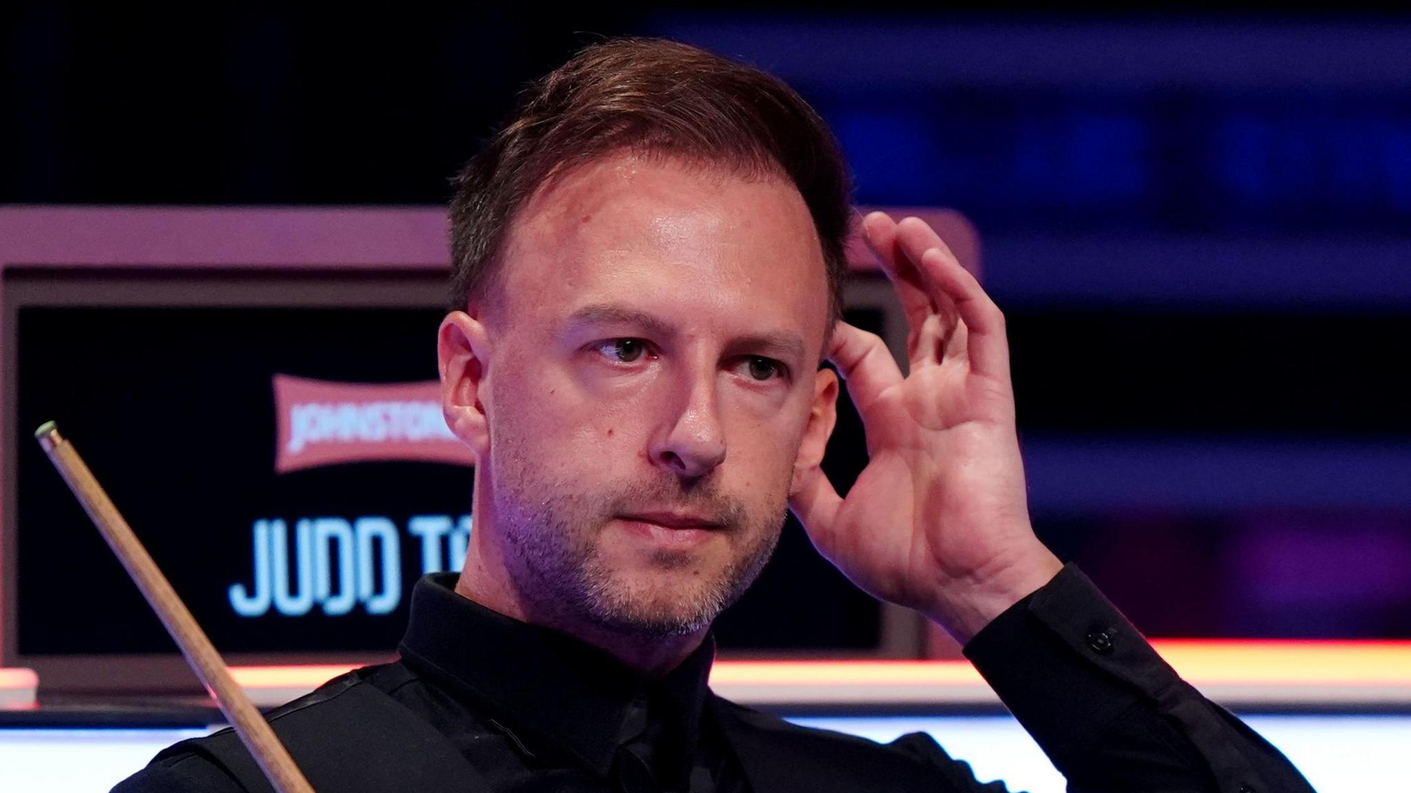 Judd Trump sits in his chair