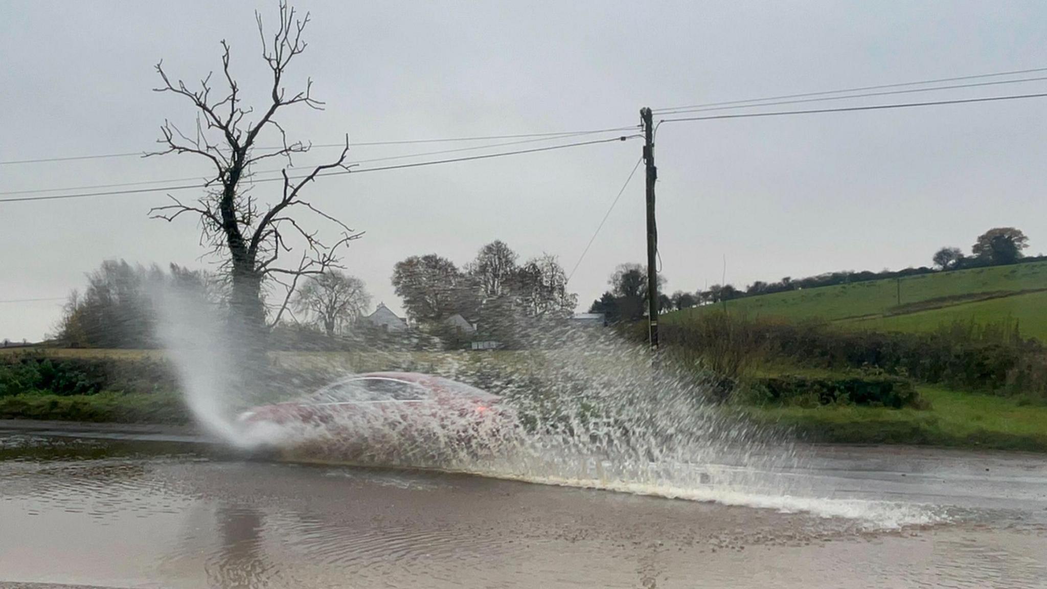 A car driving through a flooded road in Cookstown, Co Tyrone