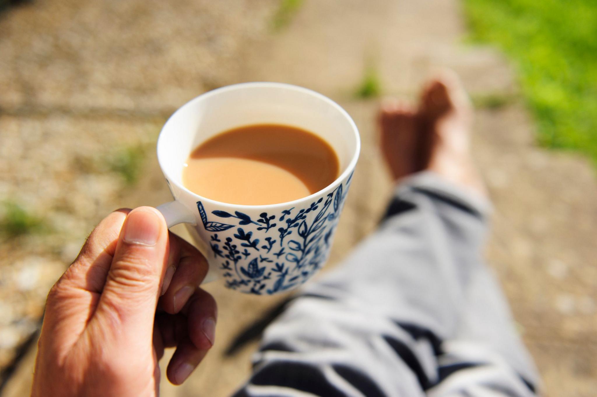 Close-up of senior person's hand holding a cup of tea 