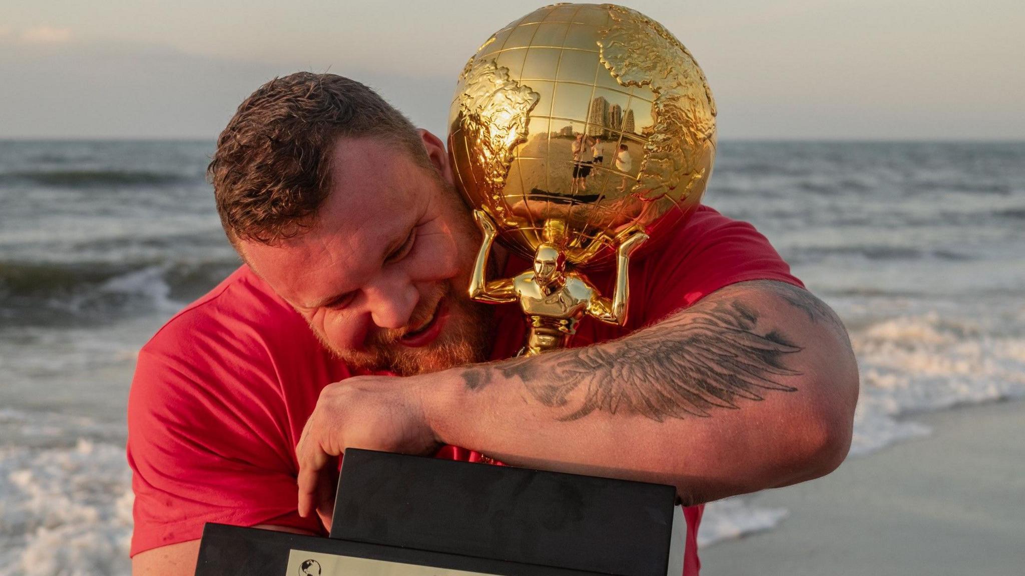 Tom Stoltman with the World's Strongest Man trophy