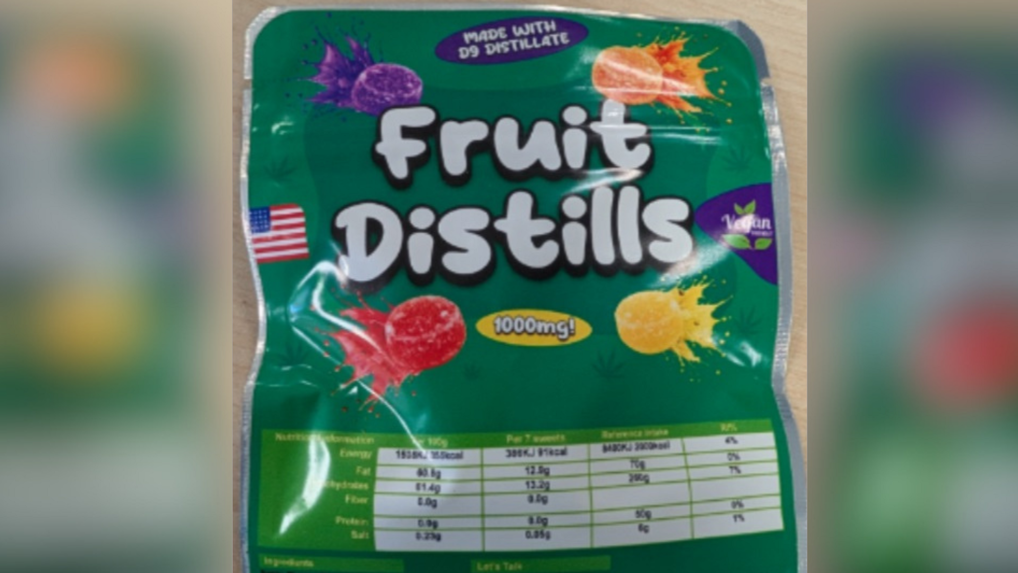 A green bag which says 'Fruit Distills', with '1,000mg' written in a yellow bubble and images of sweets. It looks similar to a packet of Fruit Pastilles.