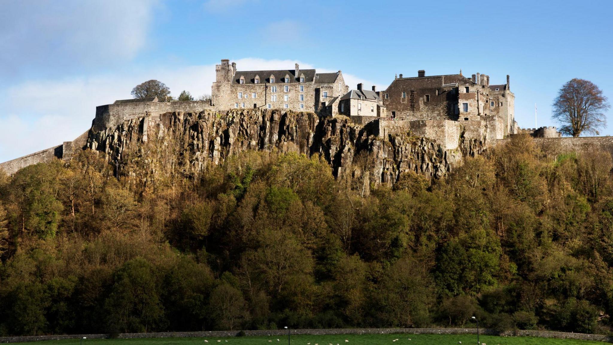 Stirling Castle sits on a volcanic crag. It is a complex of stout, stone-built properties with narrow windows.