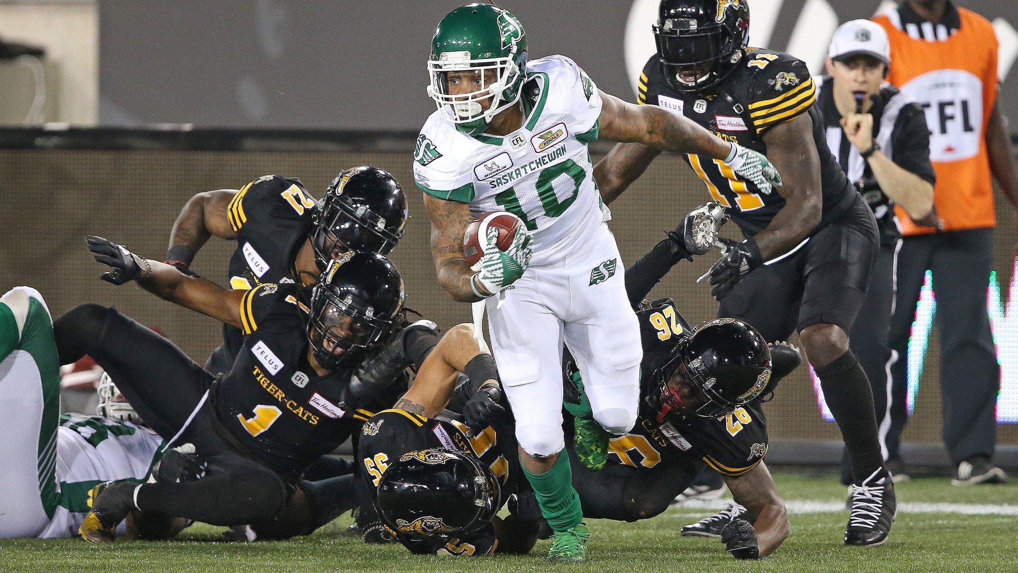 CFA - HAMILTON, ON - JULY 19: Tre Mason #10 of the Saskatchewan Roughriders eludes a series of tackles against the Hamilton Tiger-Cats in a CFL game at Tim Hortons Field on July 19, 2018 in Hamilton, Ontario,Canada. The Roughriders defeated the Tiger-Cats 31-20. (Photo by Claus Andersen/Getty Images)