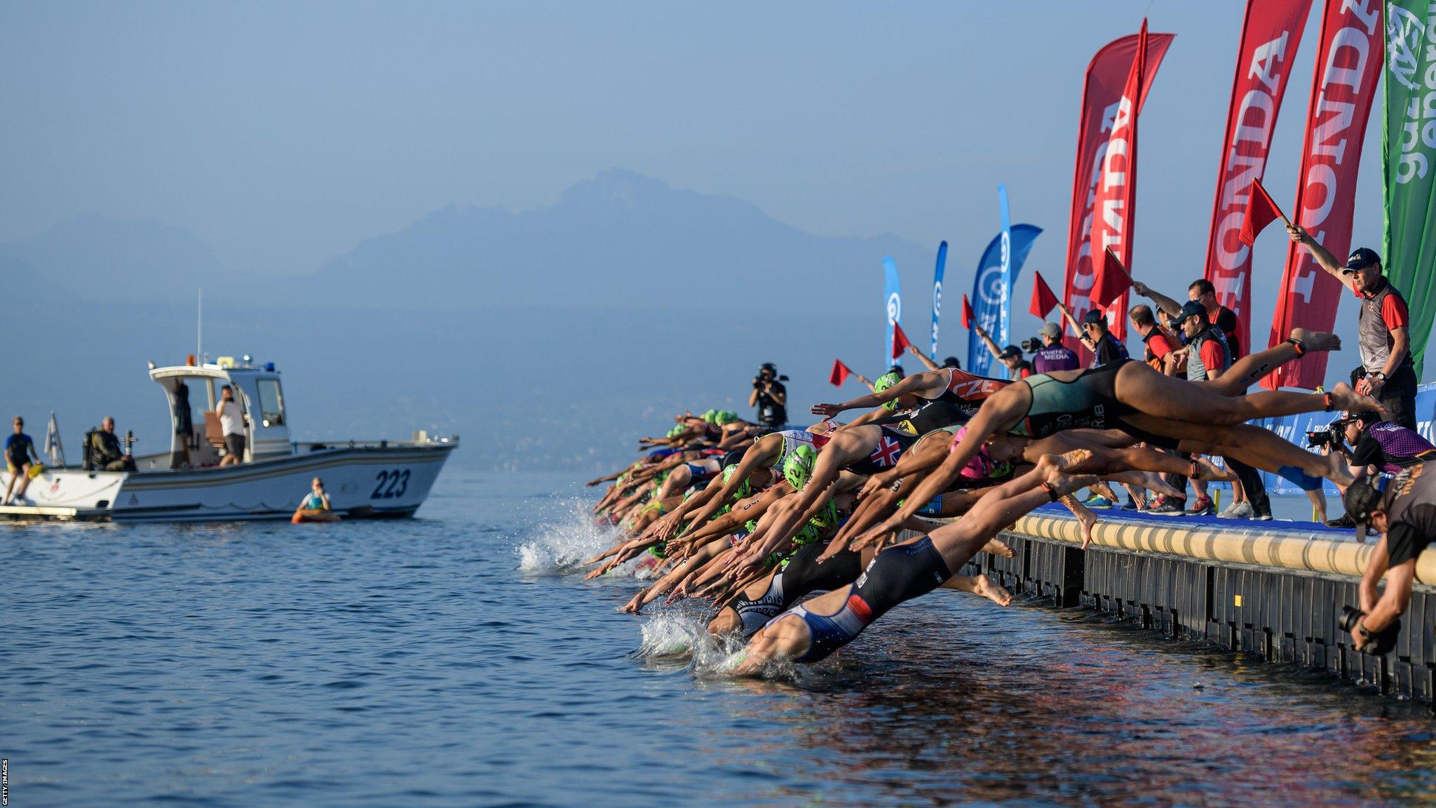 LAUSANNE, SWITZERLAND - AUGUST 30: The Swim start in front of the alps during the women's junior sprint race at the ITU World Triathlon Grand Final on August 30, 2019 in Lausanne, Switzerland. (Photo by Jörg Schüler/Getty Images)