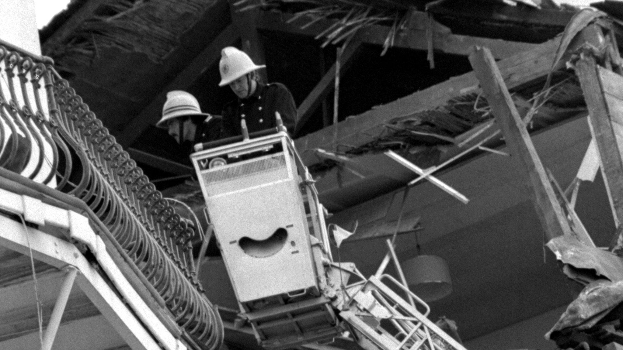 Firefighters inspect the hotel wreckage