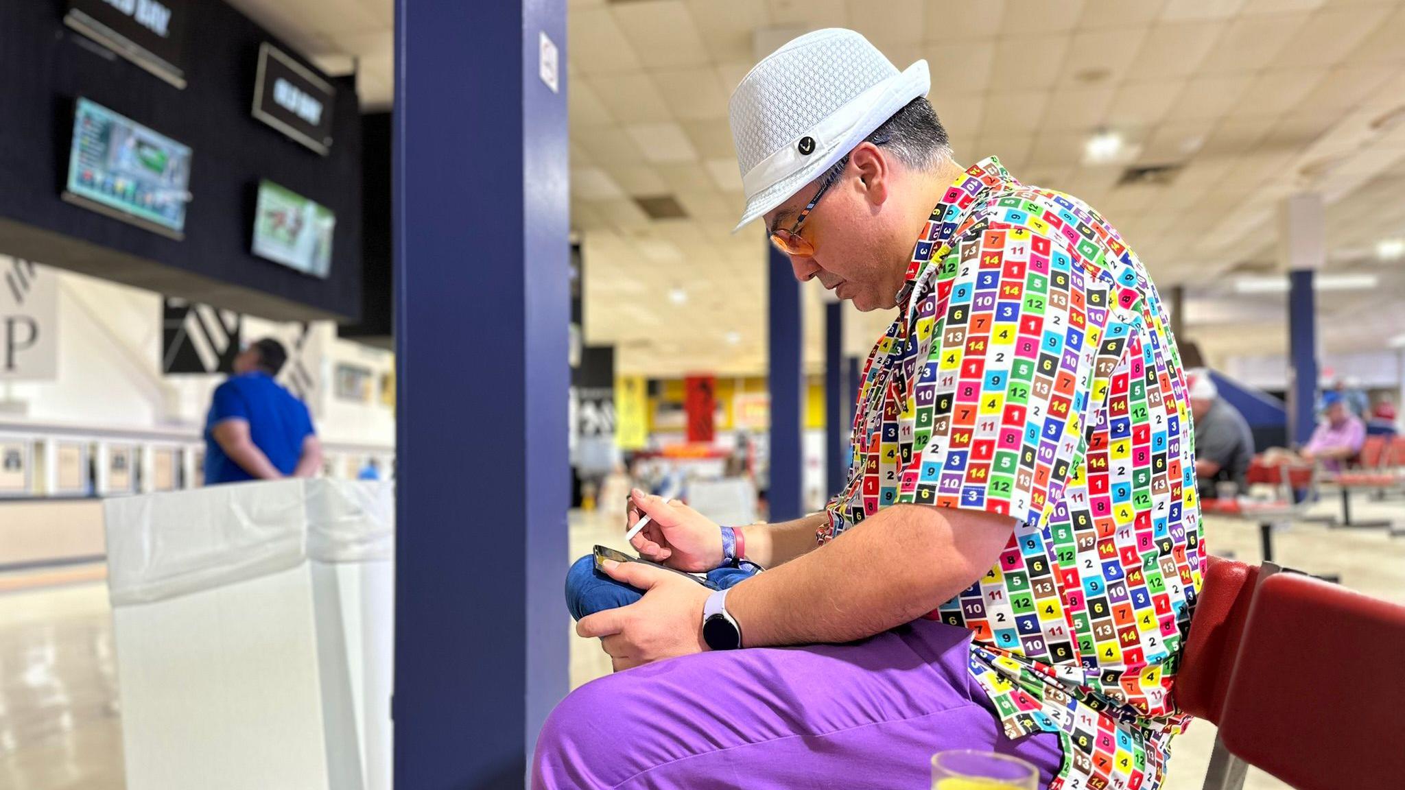 Ray De Rubin scans through the betting app on his iPad