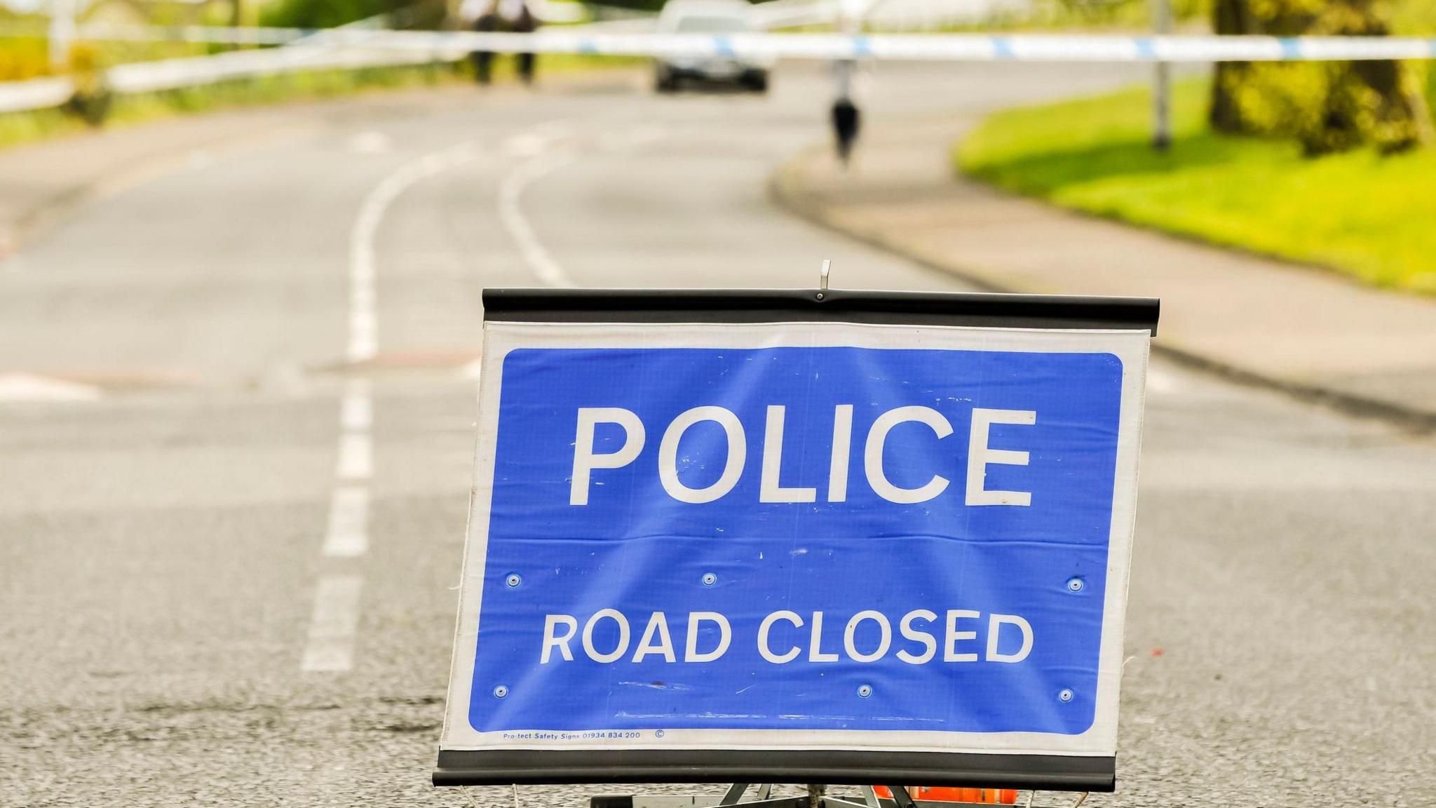 Police close a road during a security alert - stock photo