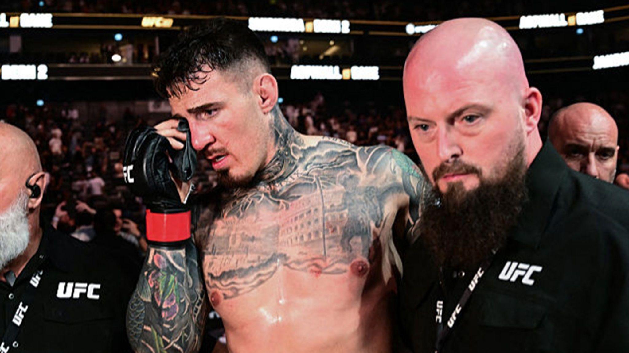 Tom Aspinall holds his right eye after his UFC 321 bout with Cyril Gane