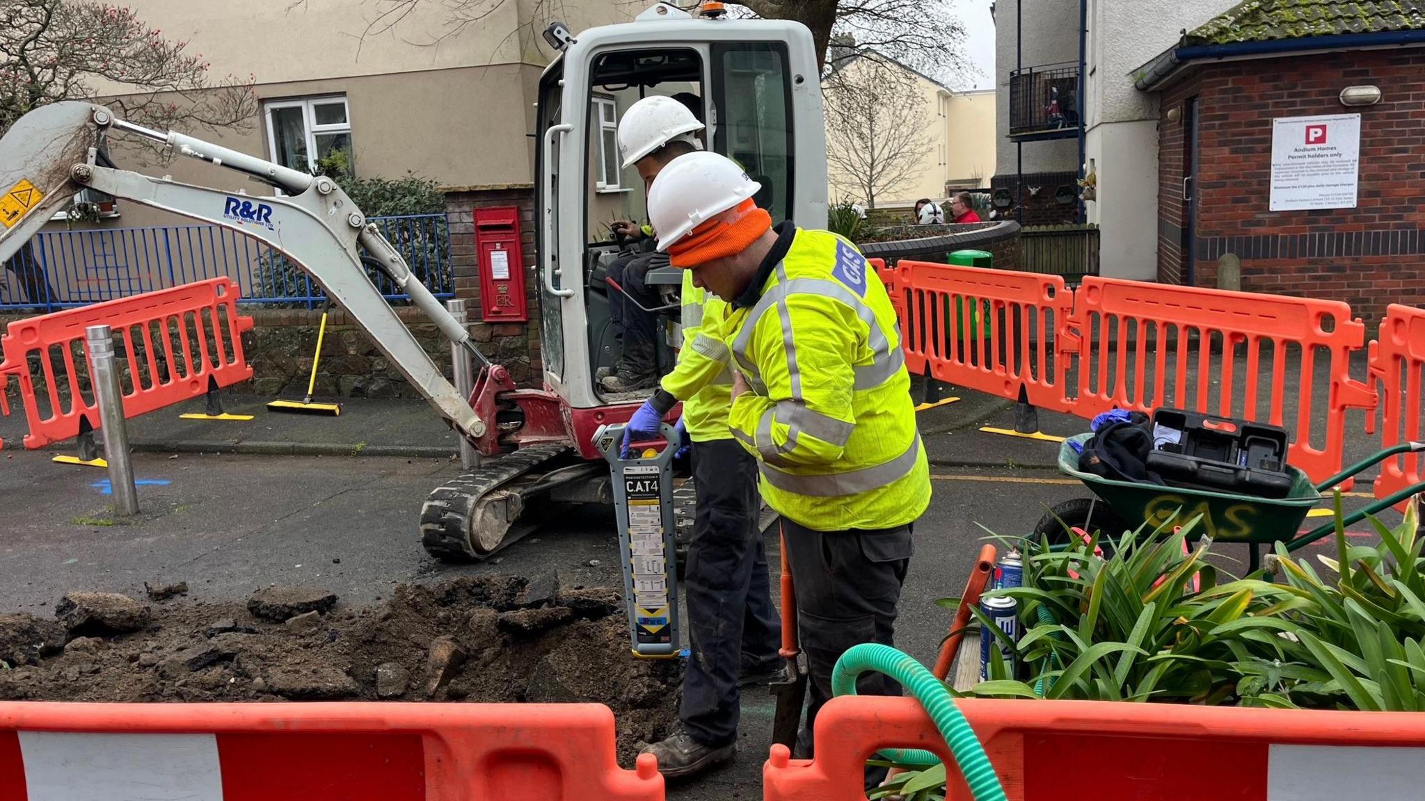 Workers at the site of the potential gas leak scene in Jersey