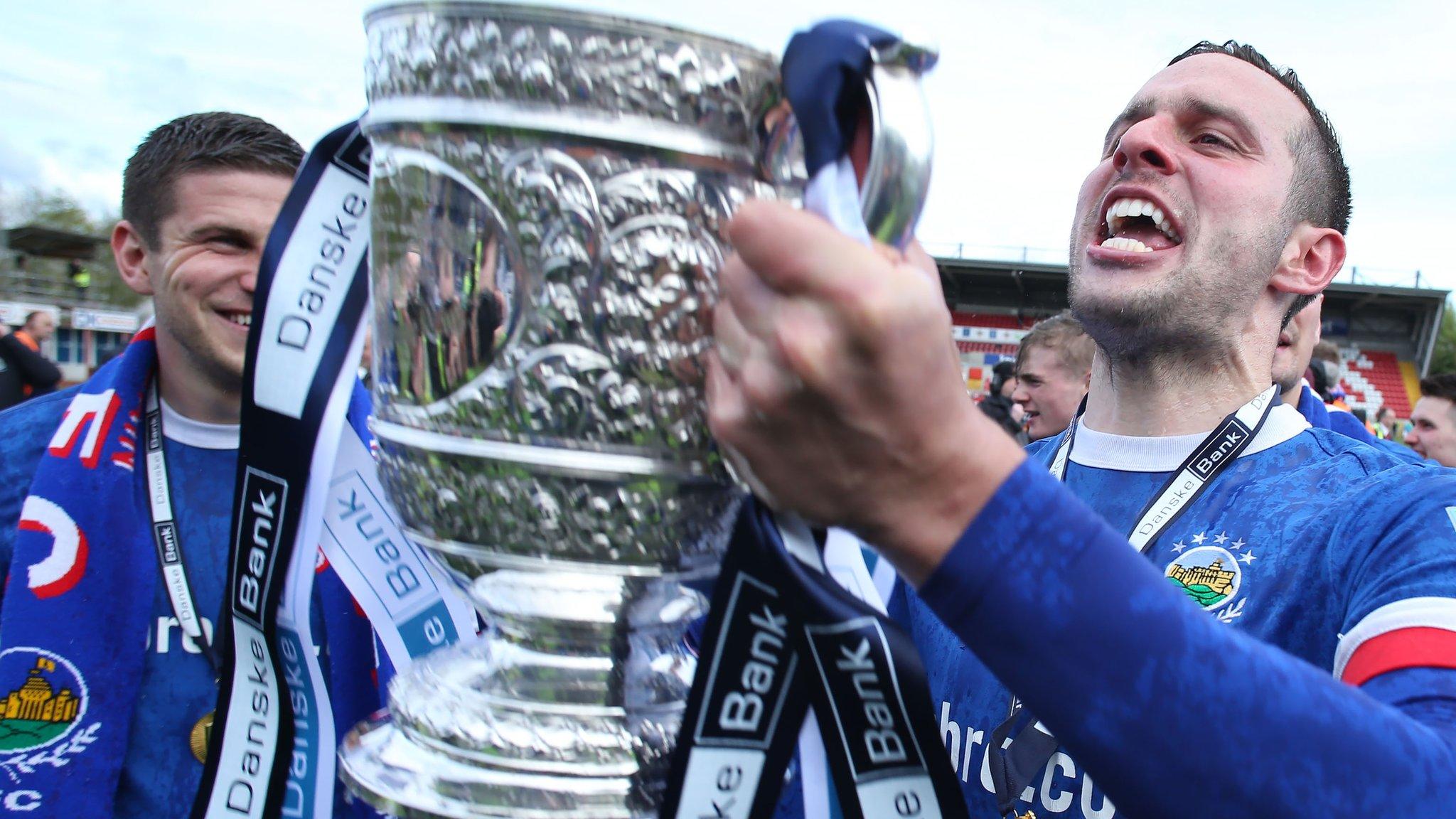 Linfield striker Andrew Waterworth celebrates with the Gibson Cup