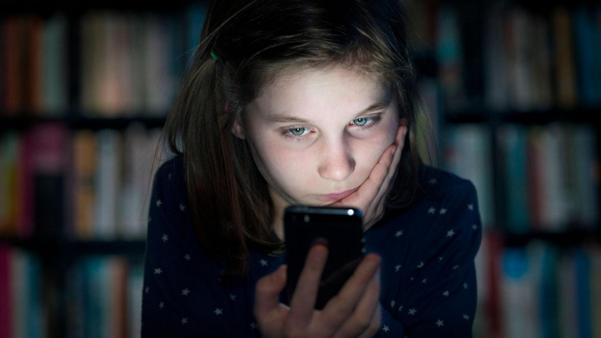 A girl looking at a phone