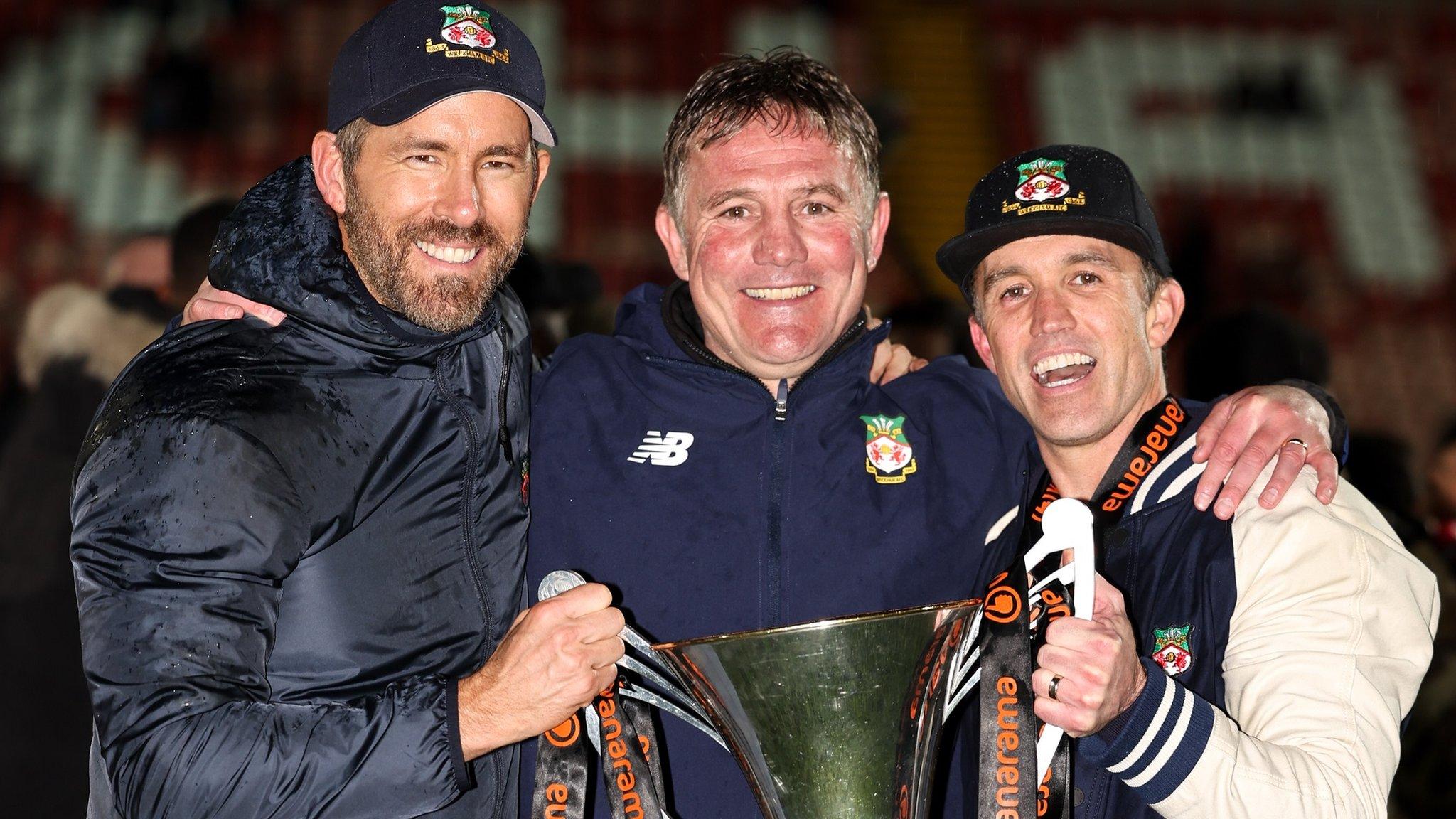 Phil Parkinson (centre) with Ryan Reynolds, Rob McElhenney and the National League trophy