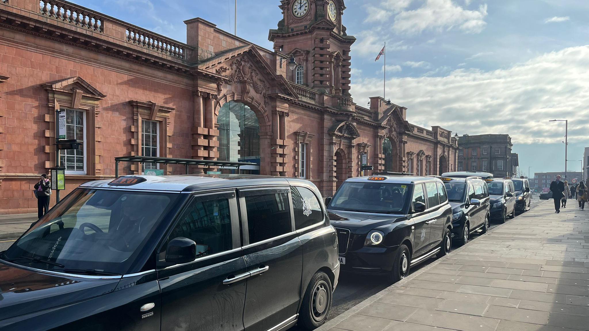 Black taxis lined up outside Nottingham Railway Station