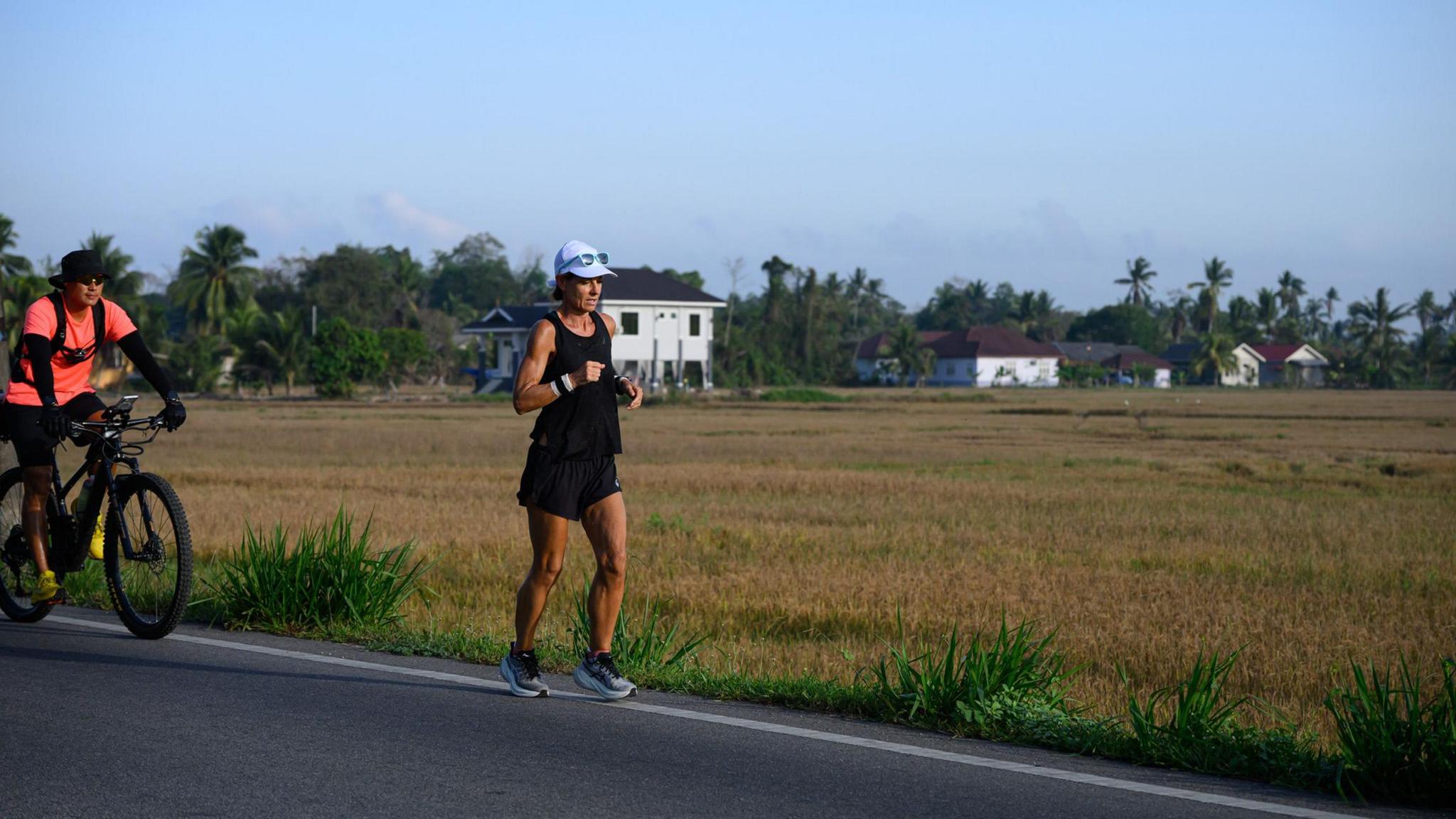 Natalie Dau and her fitness coach Arthur Tong on a bicycle