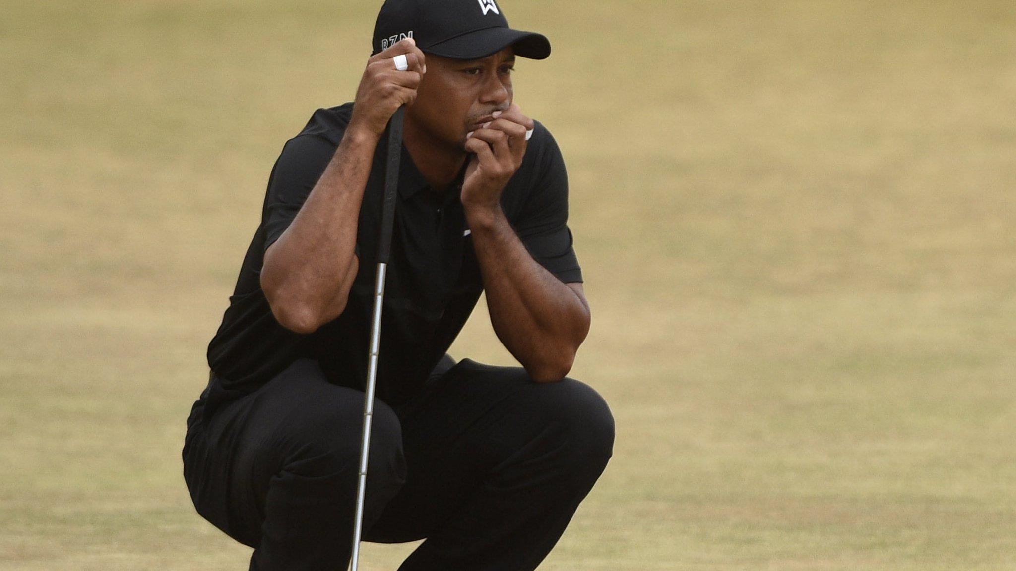 Tiger Woods lines up his shot