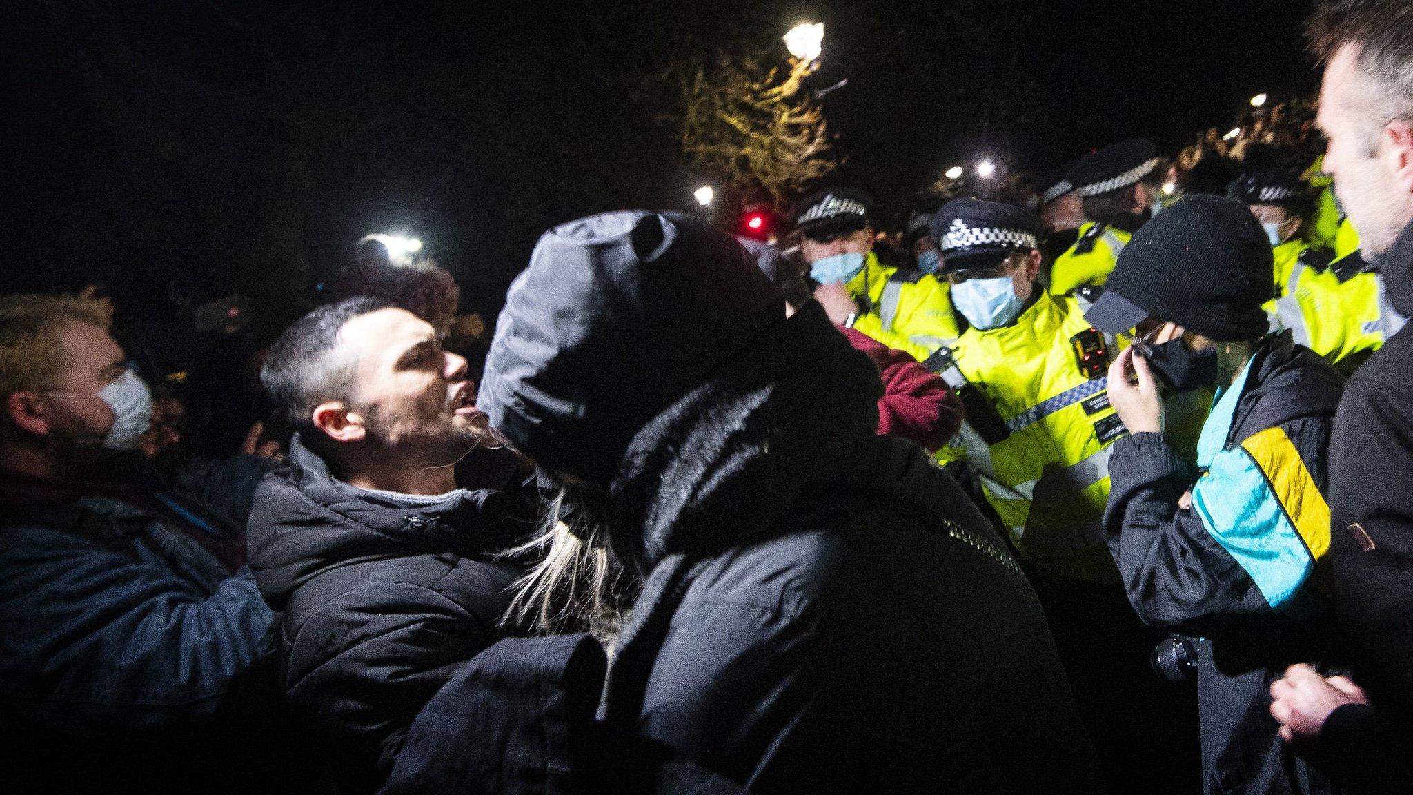 Men challenge the police line at Saturday's vigil to Sarah Everard